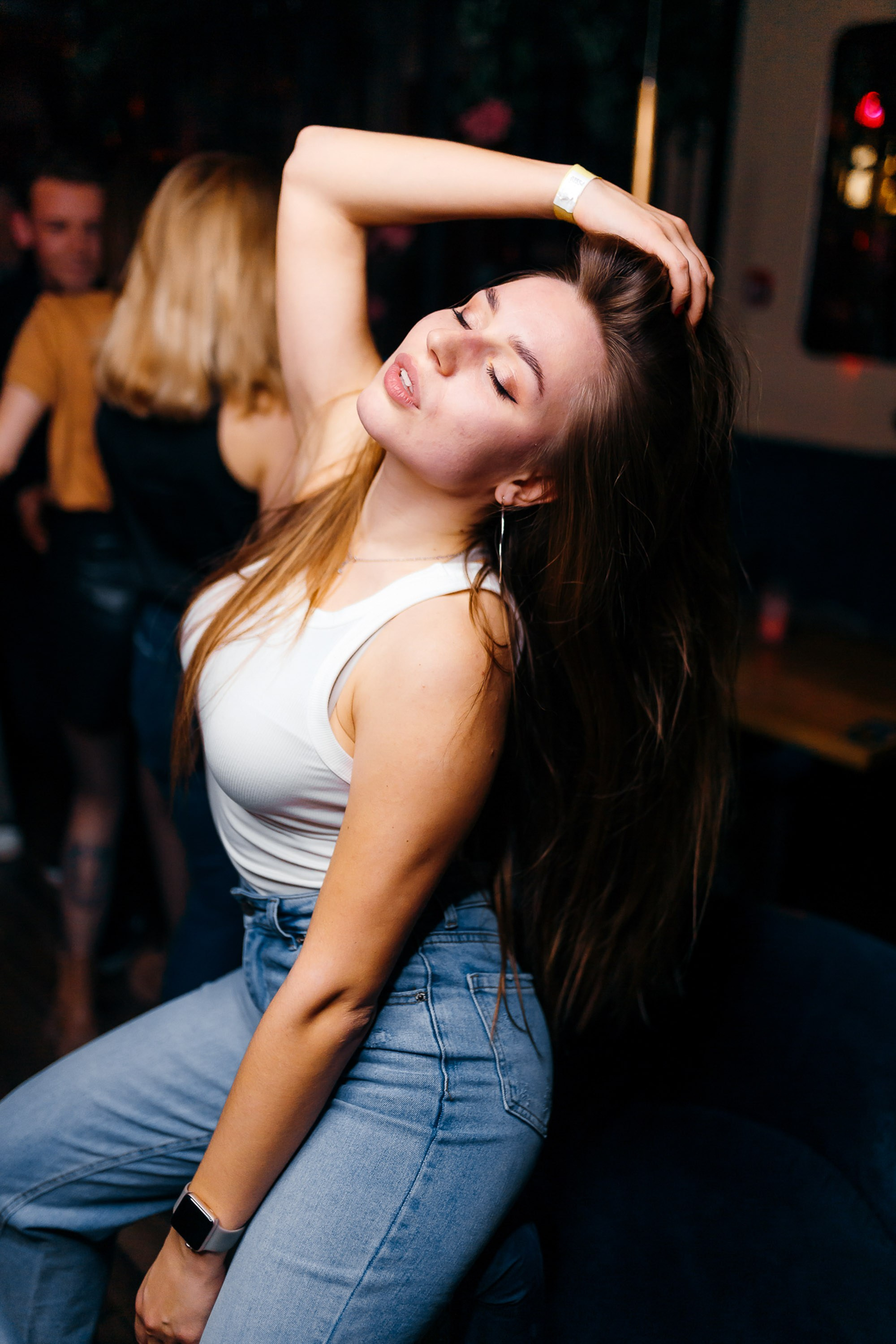 Woman dancing at club, energetic party scene