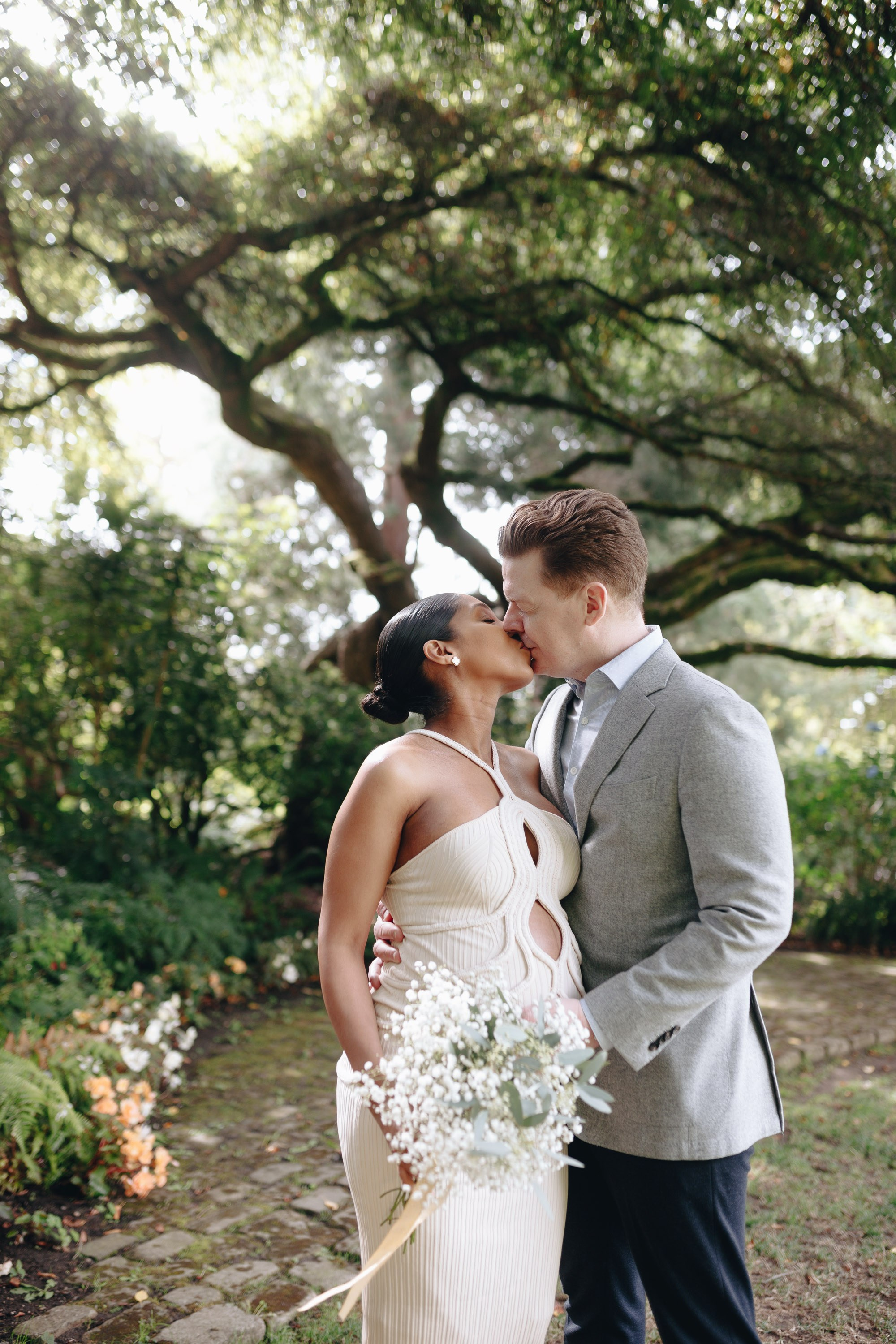 Bride and groom laughing together outdoors