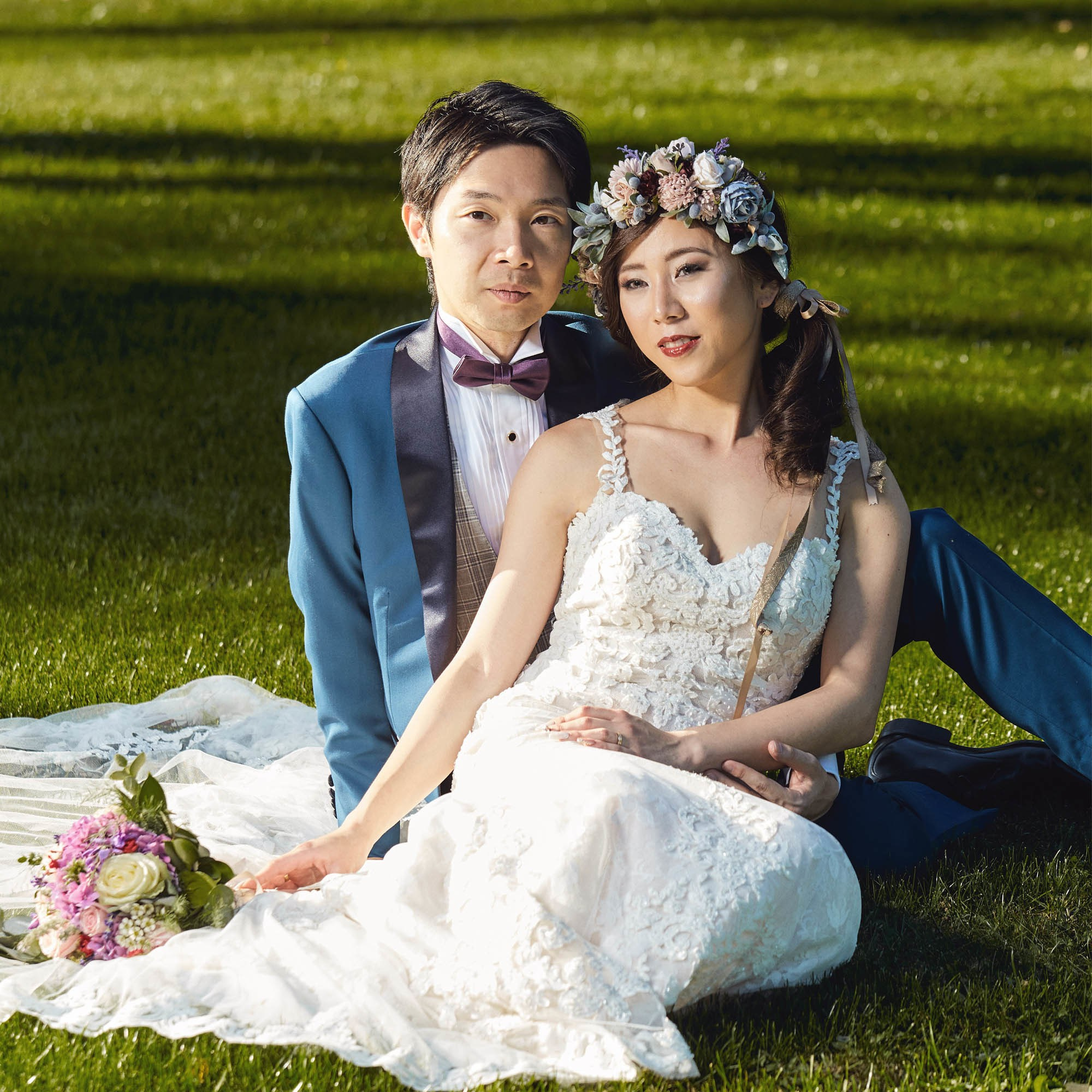 Relaxed couple portrait sitting grass Vila Bled Lake Bled view.