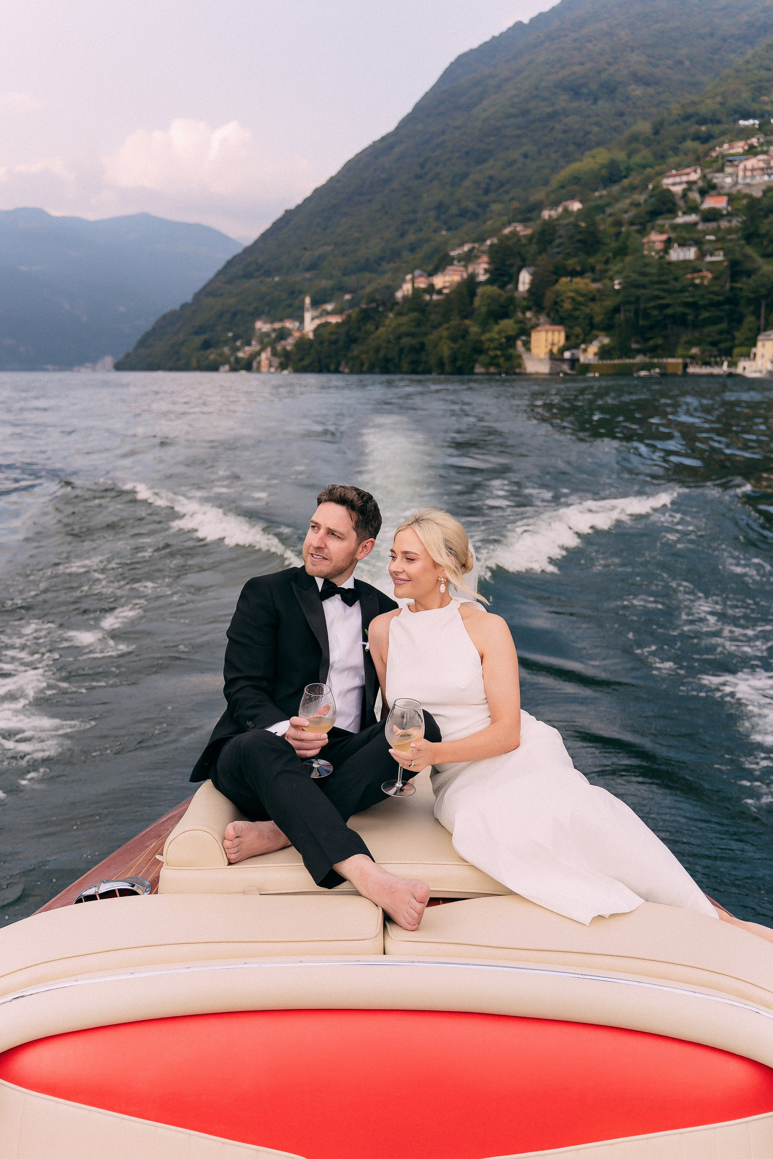 Bride and groom riding the boat across Lake Como at Villa Lario, Italy