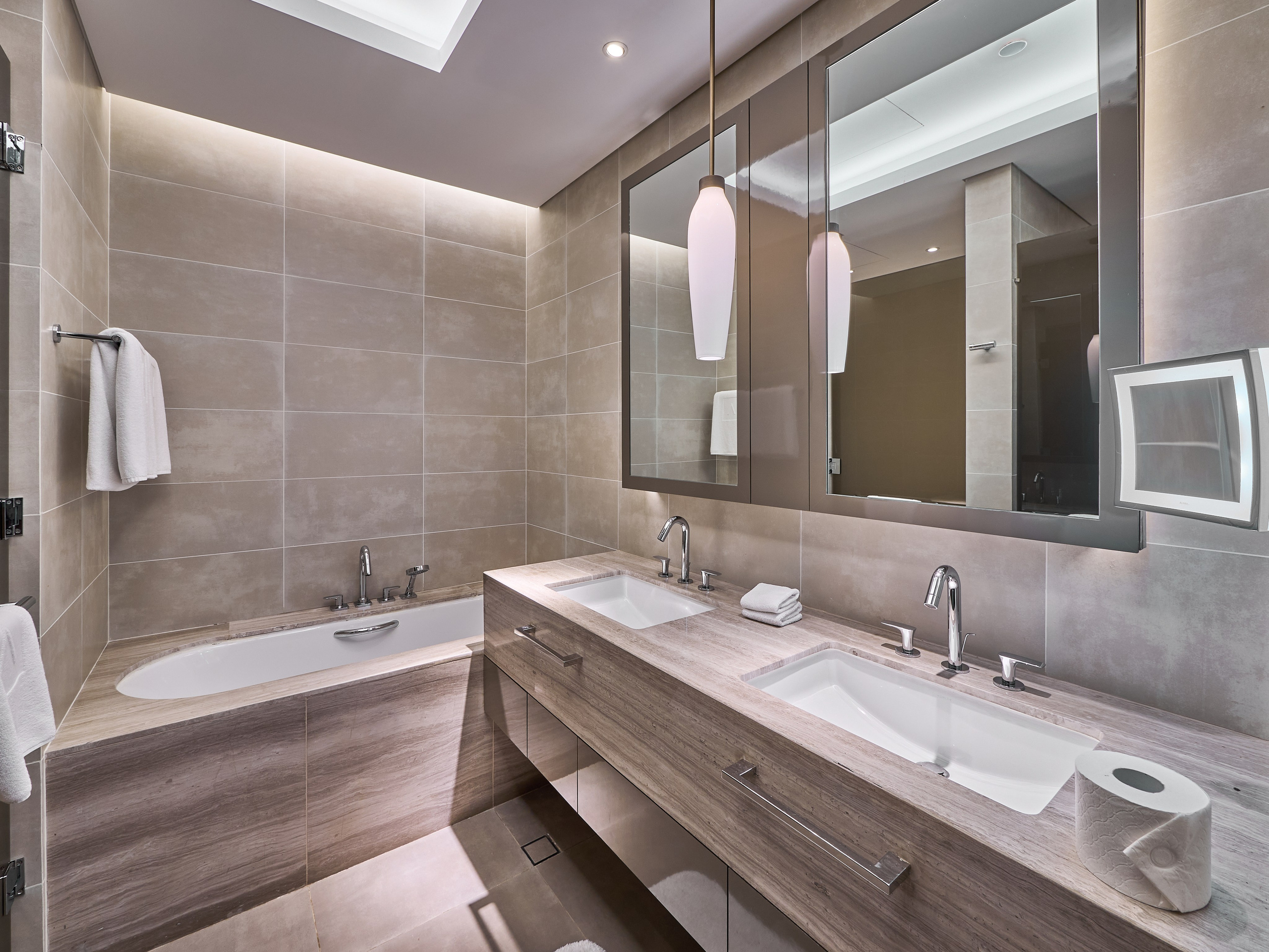 Spacious marble bathroom with dual sinks in upscale Dubai apartment. Interior photography by Oleg Novikov for Airbnb and real estate agencies.