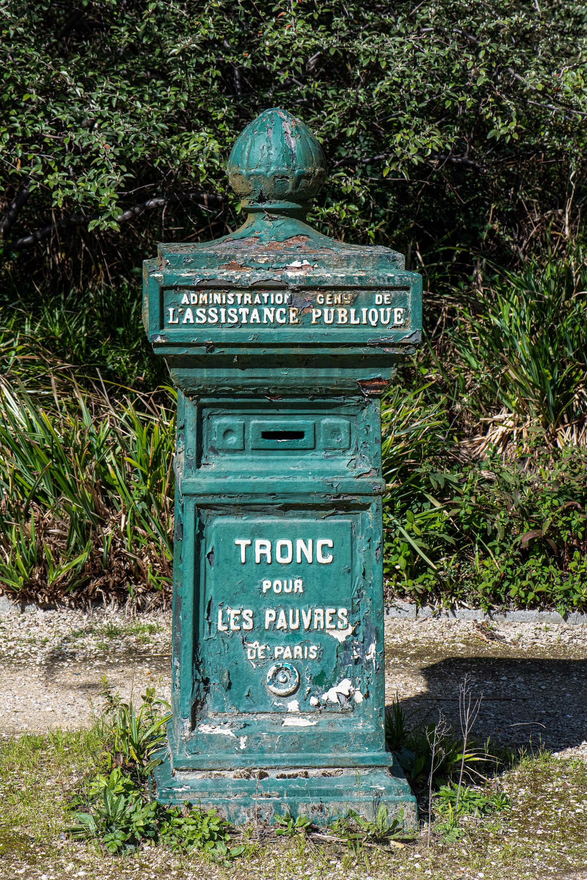 Historic donation box for the poor at Père Lachaise Cemetery in Paris, France.