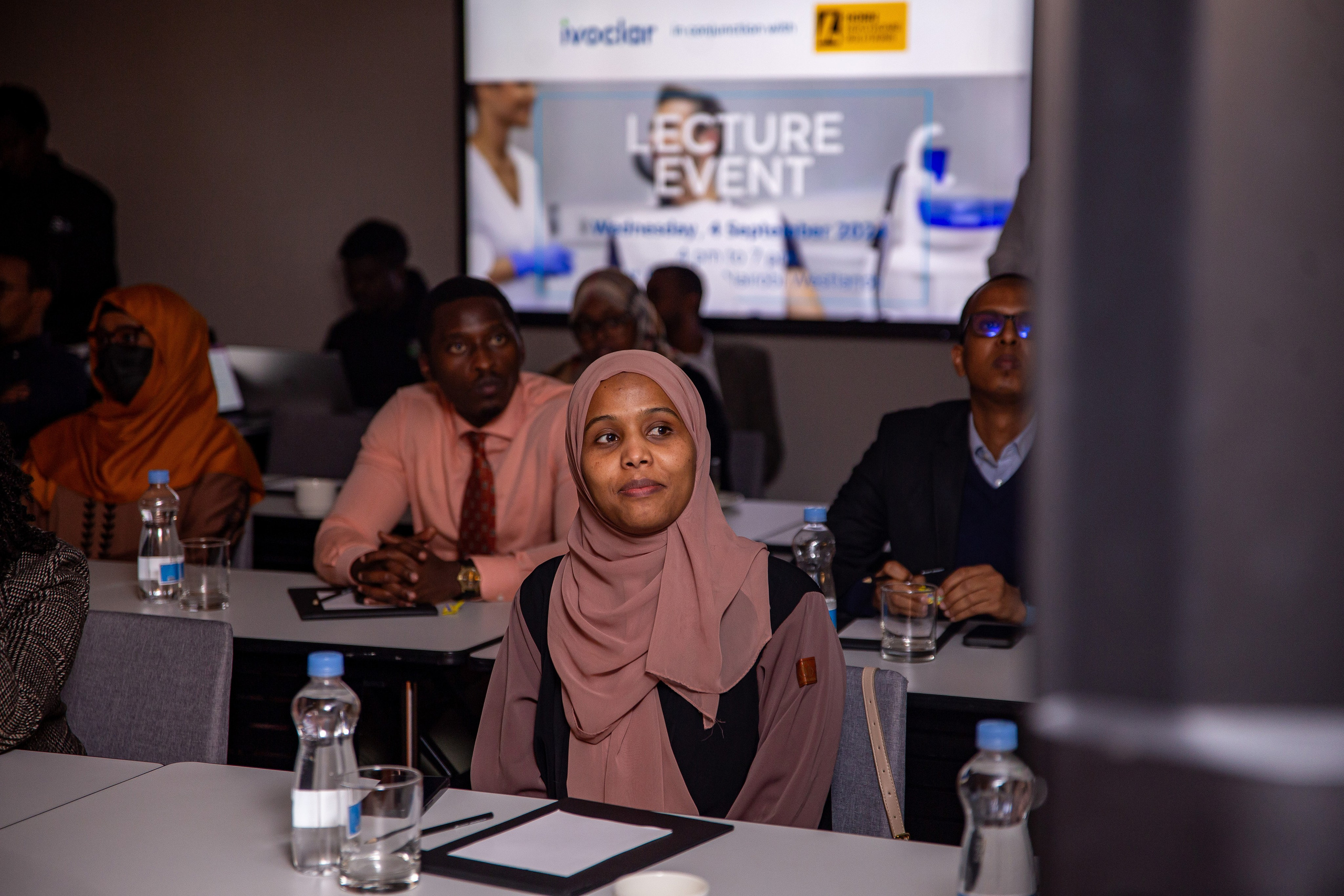 A medium portrait of an attendee listening intently at Nairobi dental symposium