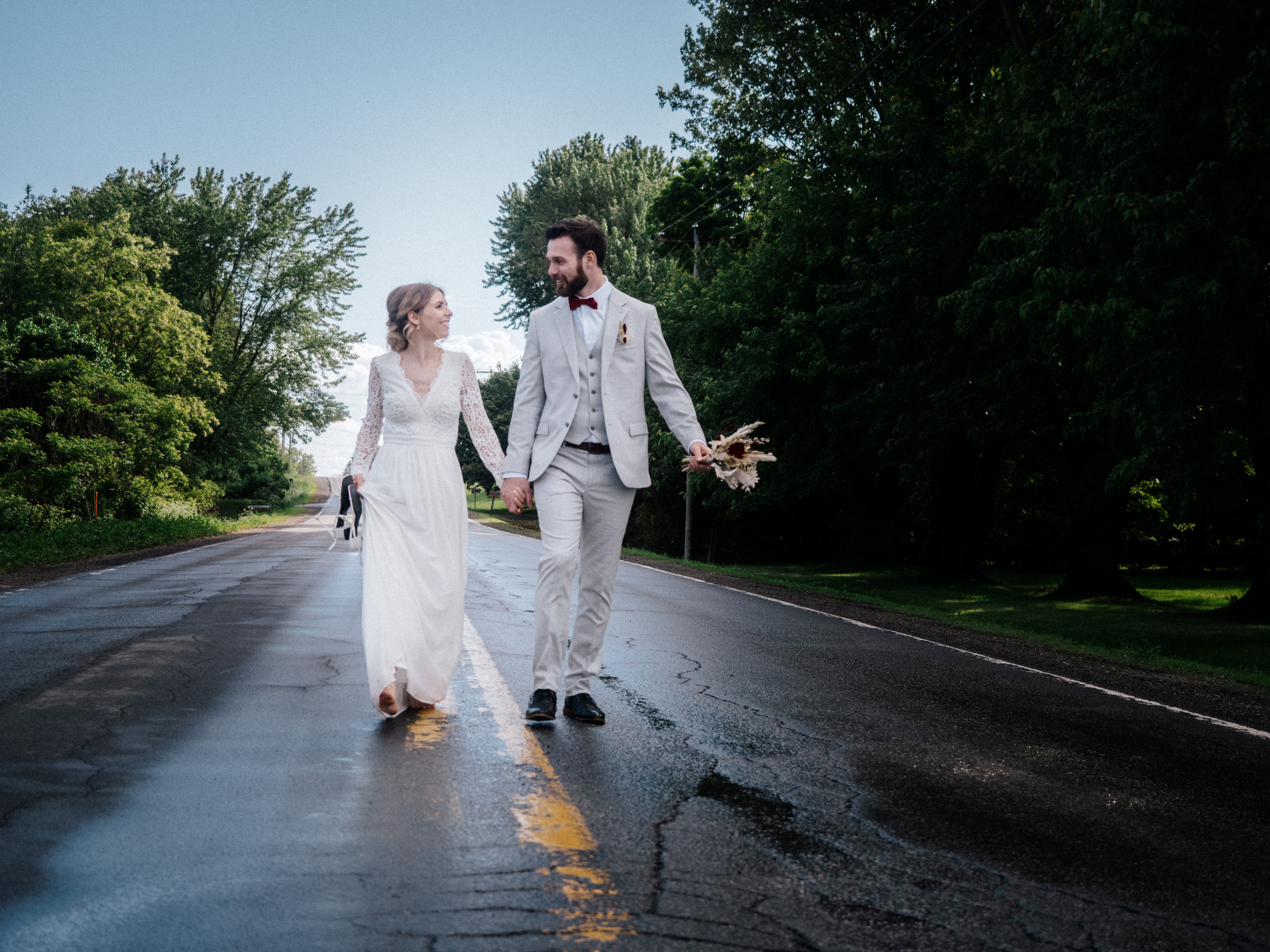 Couple walking on street wet from rain in Saint-Thomas, Quebec.
