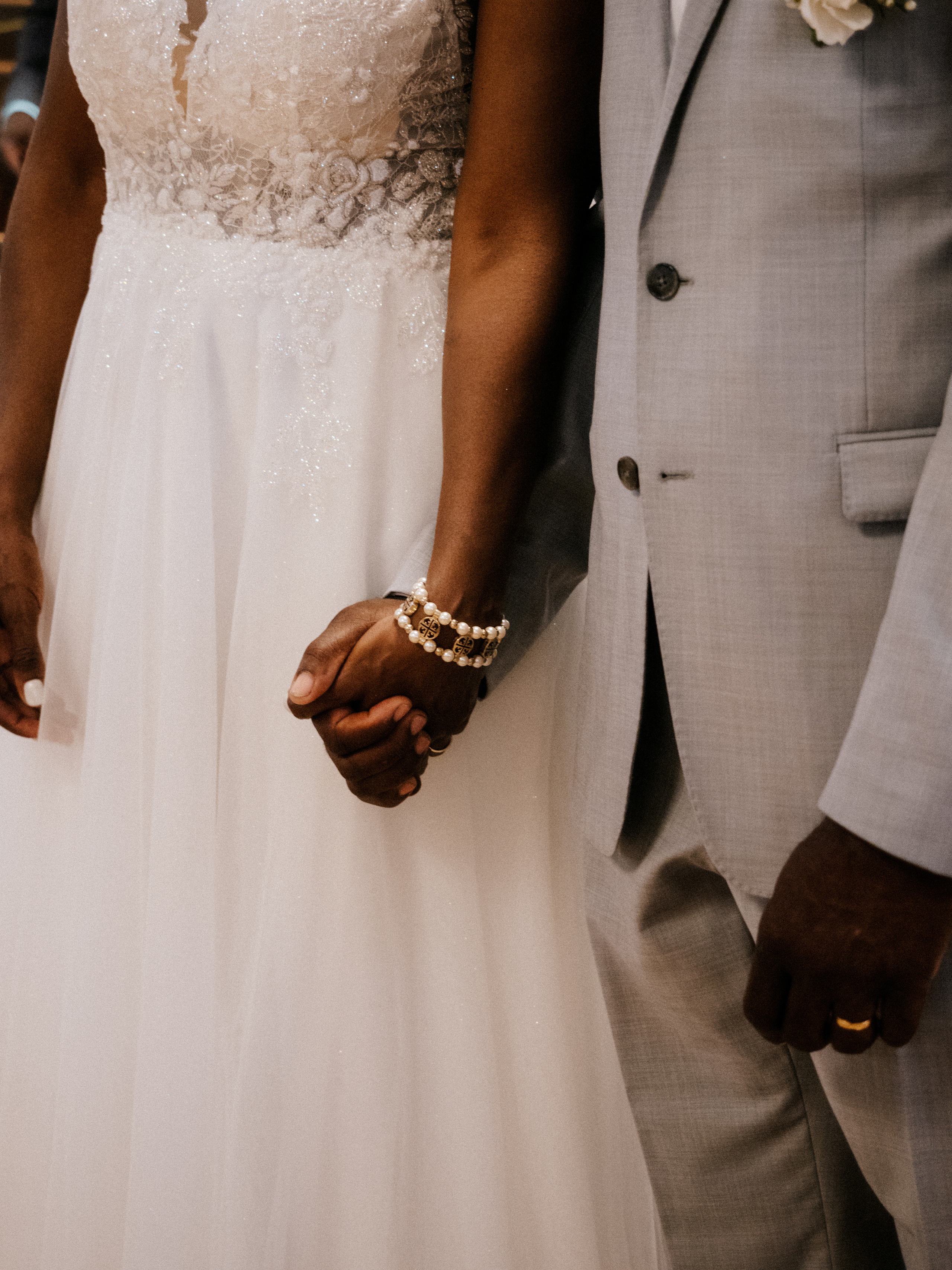 Close up of couple holding hands at church in Laval, Canada.