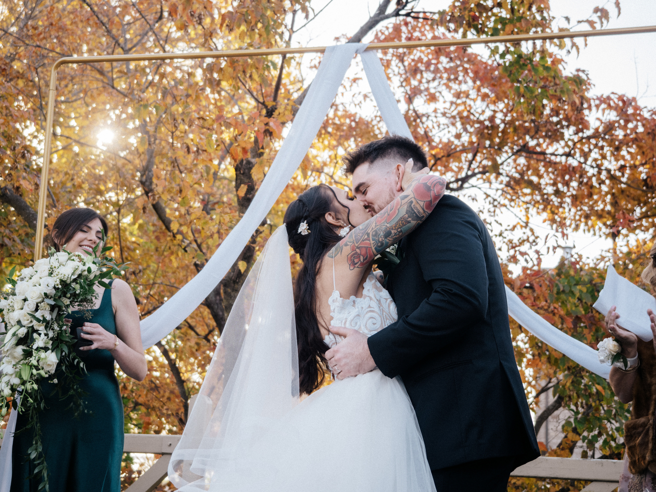 First kiss in front of colourful fall trees in Lachine, Quebec.