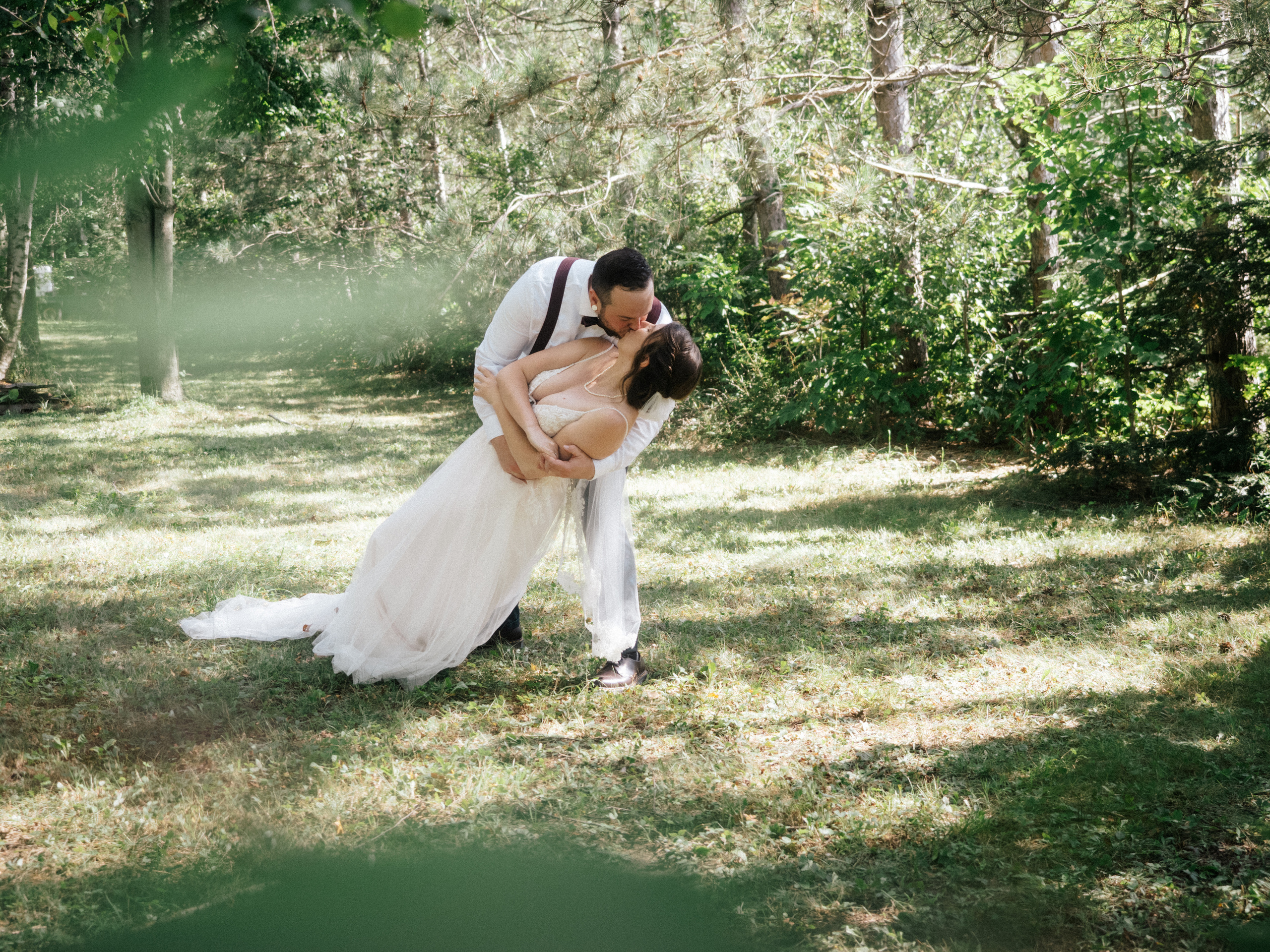 Couple kissing in forest. 