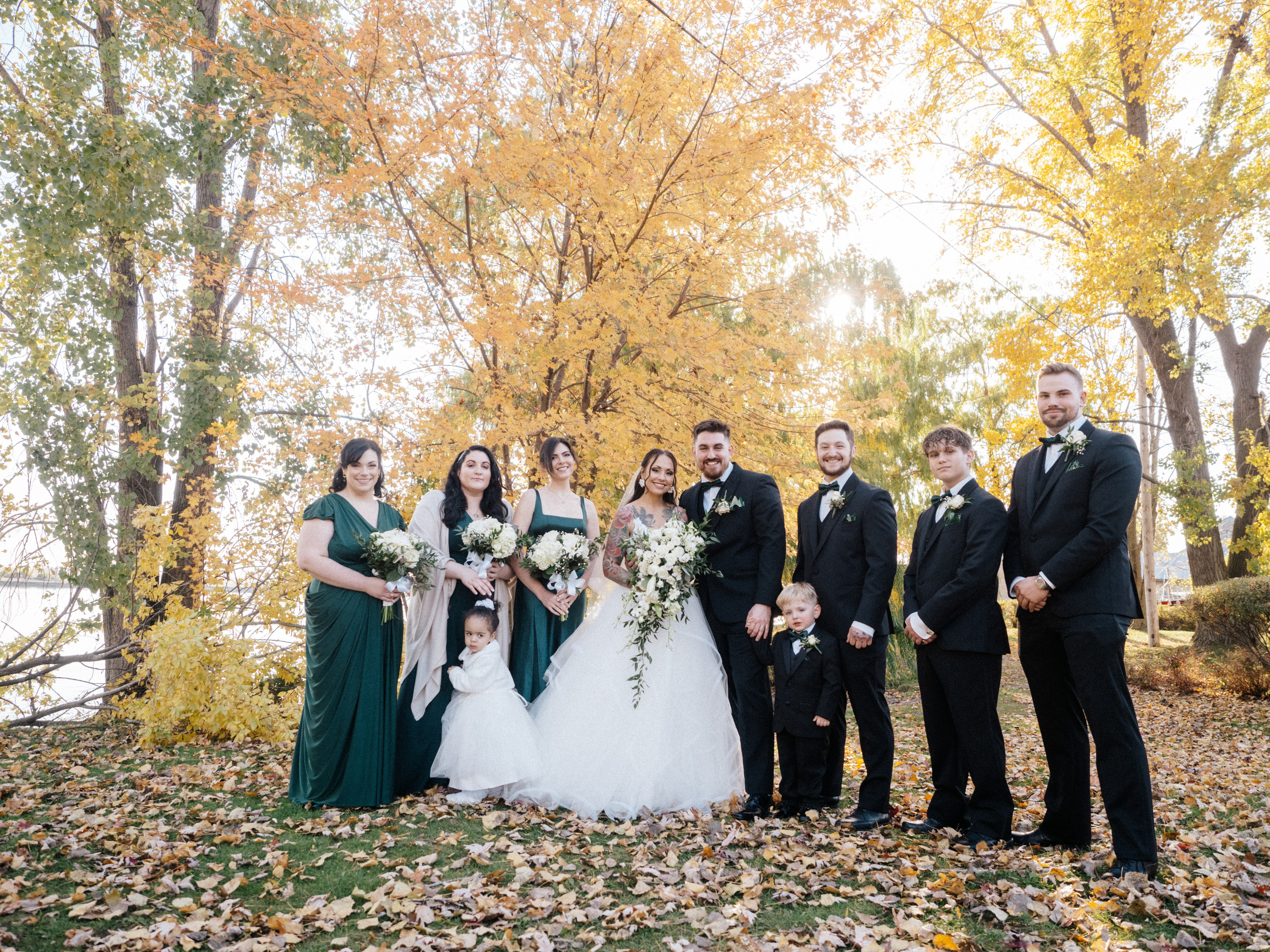 Wedding party photo surrounded by colourful fall trees in Lachine, Canada.