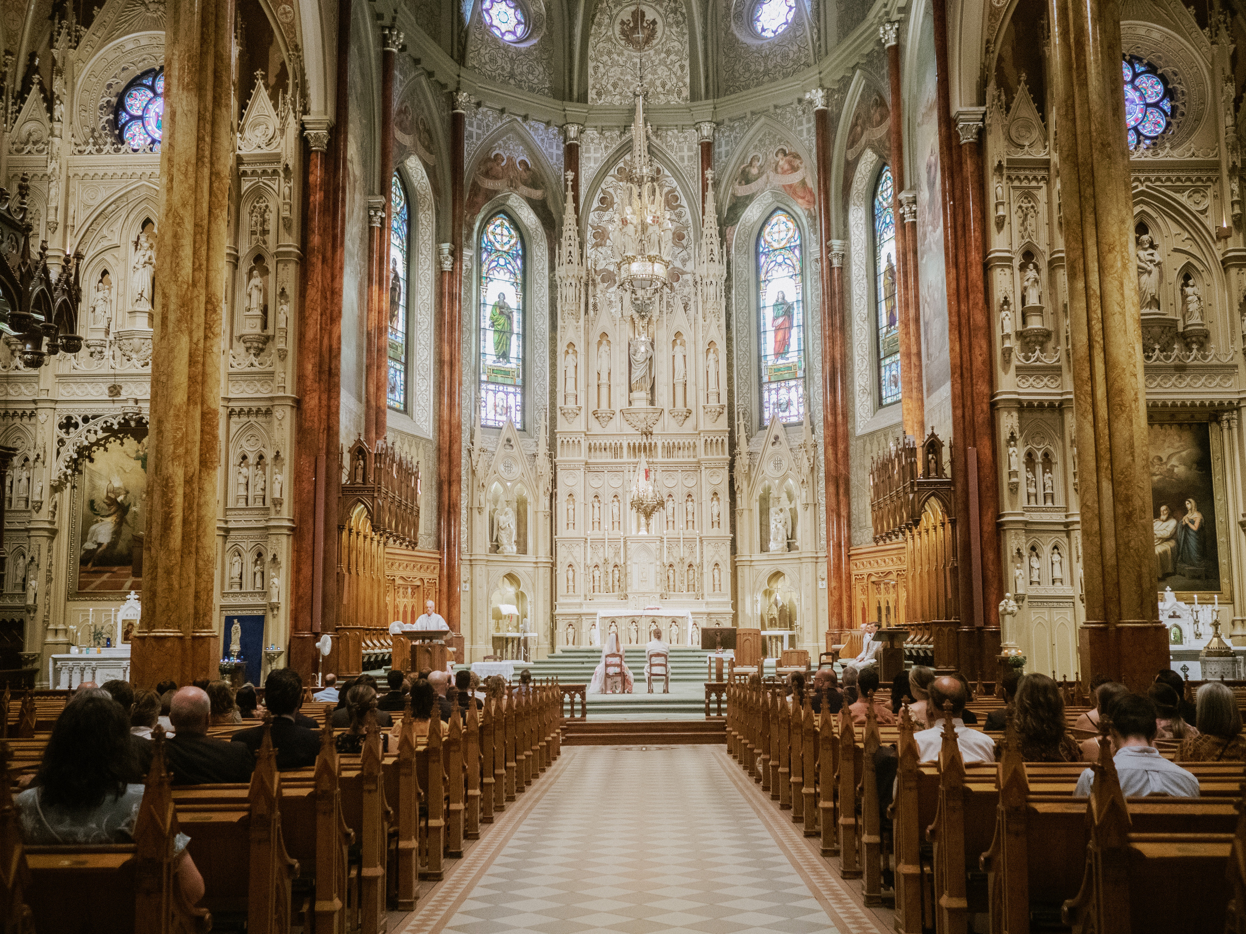 Couple getting married in Saint Patrick's Basilica in Montreal, Canada.