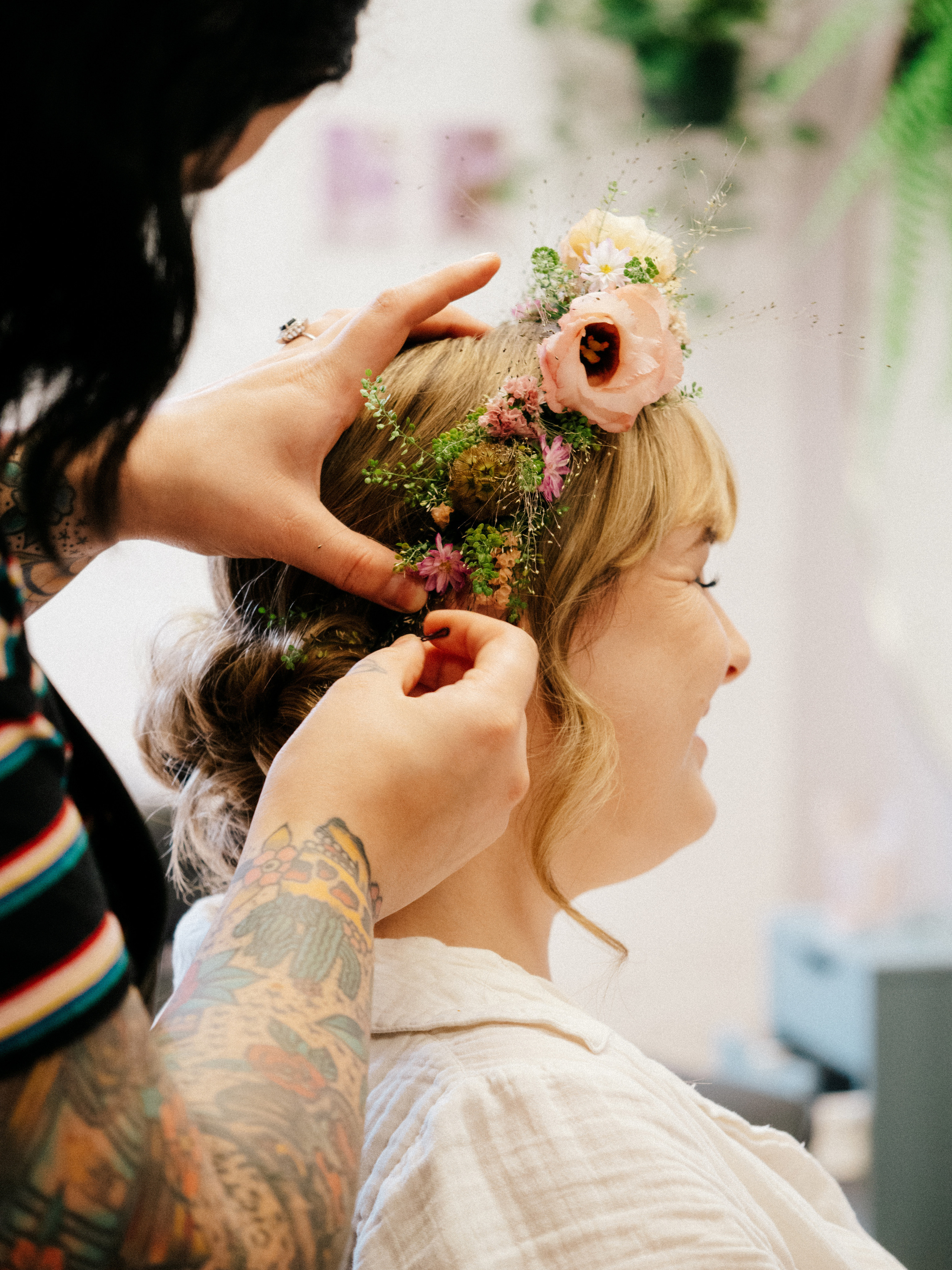 Bride with flowers in hair getting ready in Montreal, Canada.