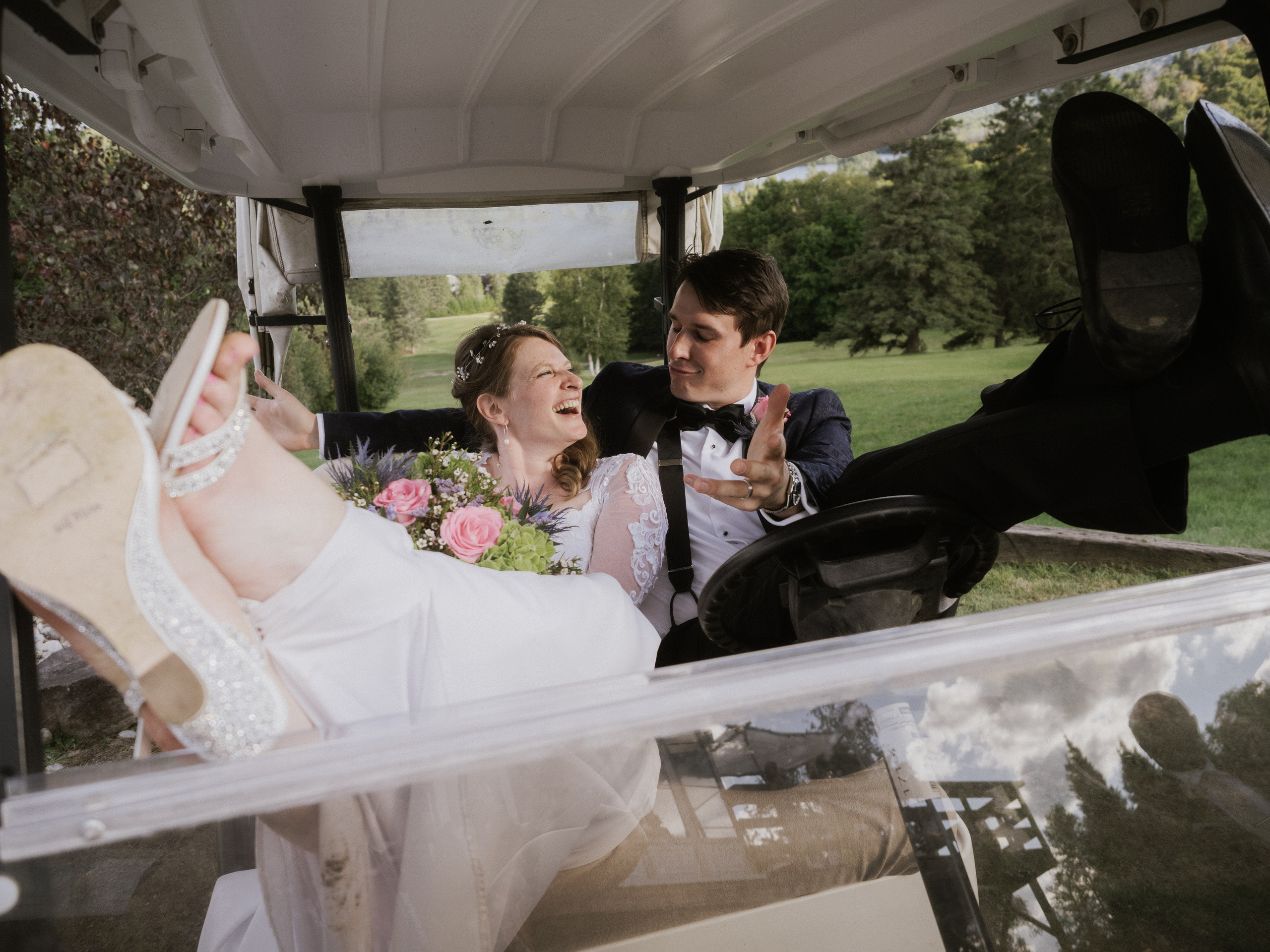 Couple sitting in golf cart in Mont Tremblant, Quebec.