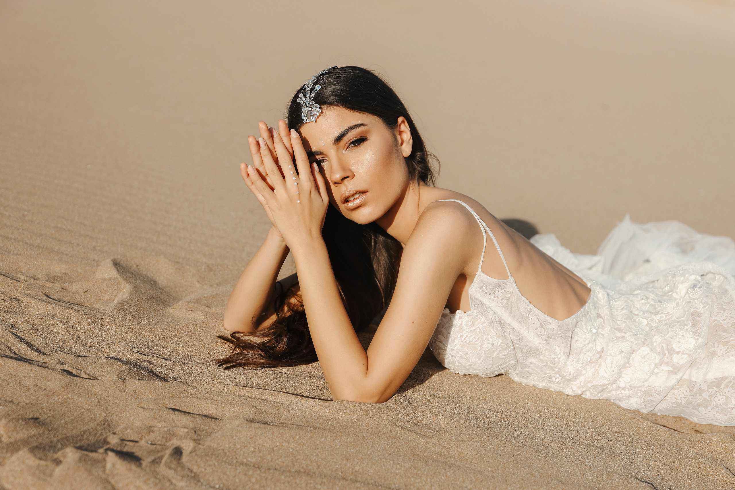 Art photoshoot of a girl in a wedding dress in the desert on a beach Tsampika in Greece