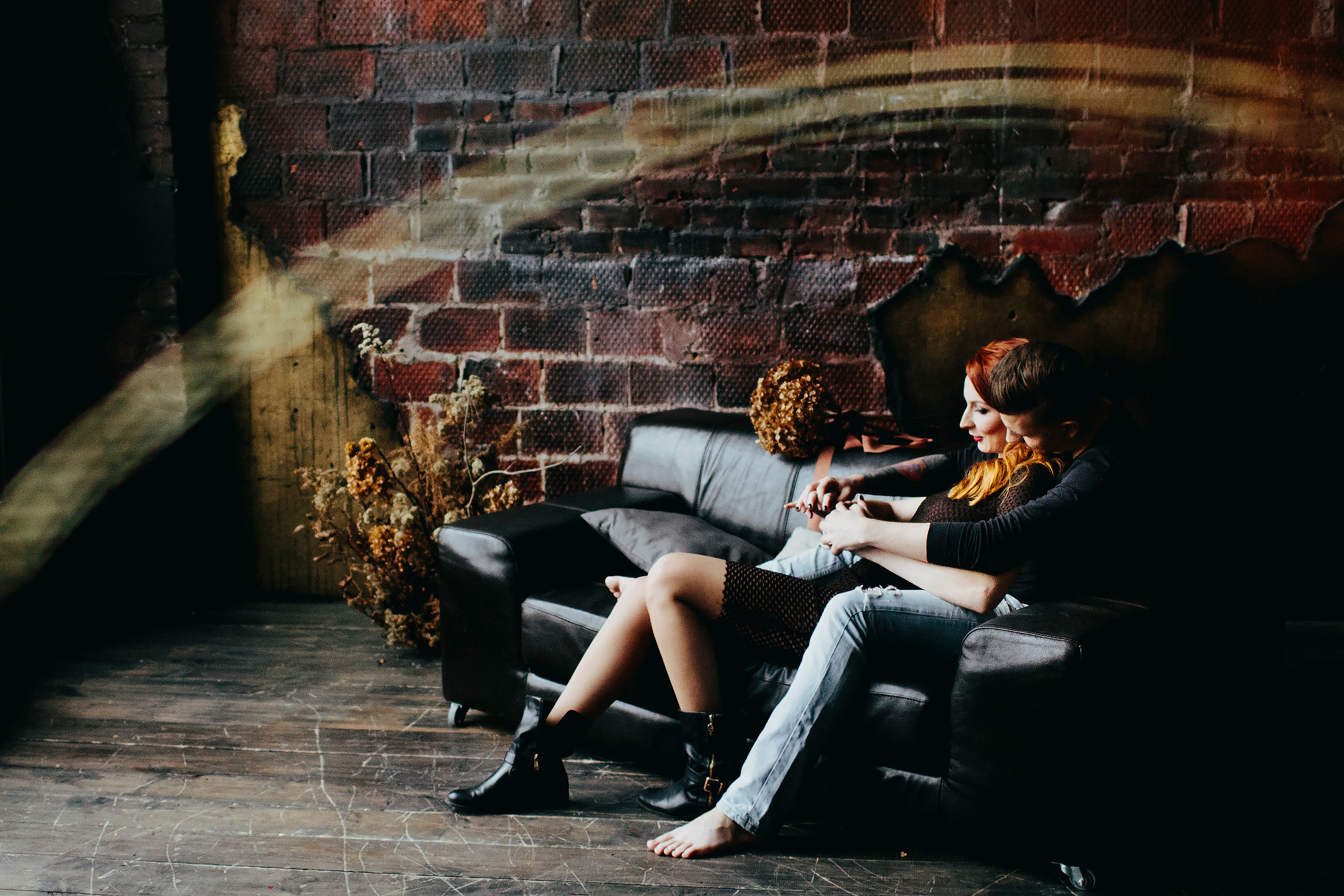 handsome man is hugging his wife sitting on the sofa