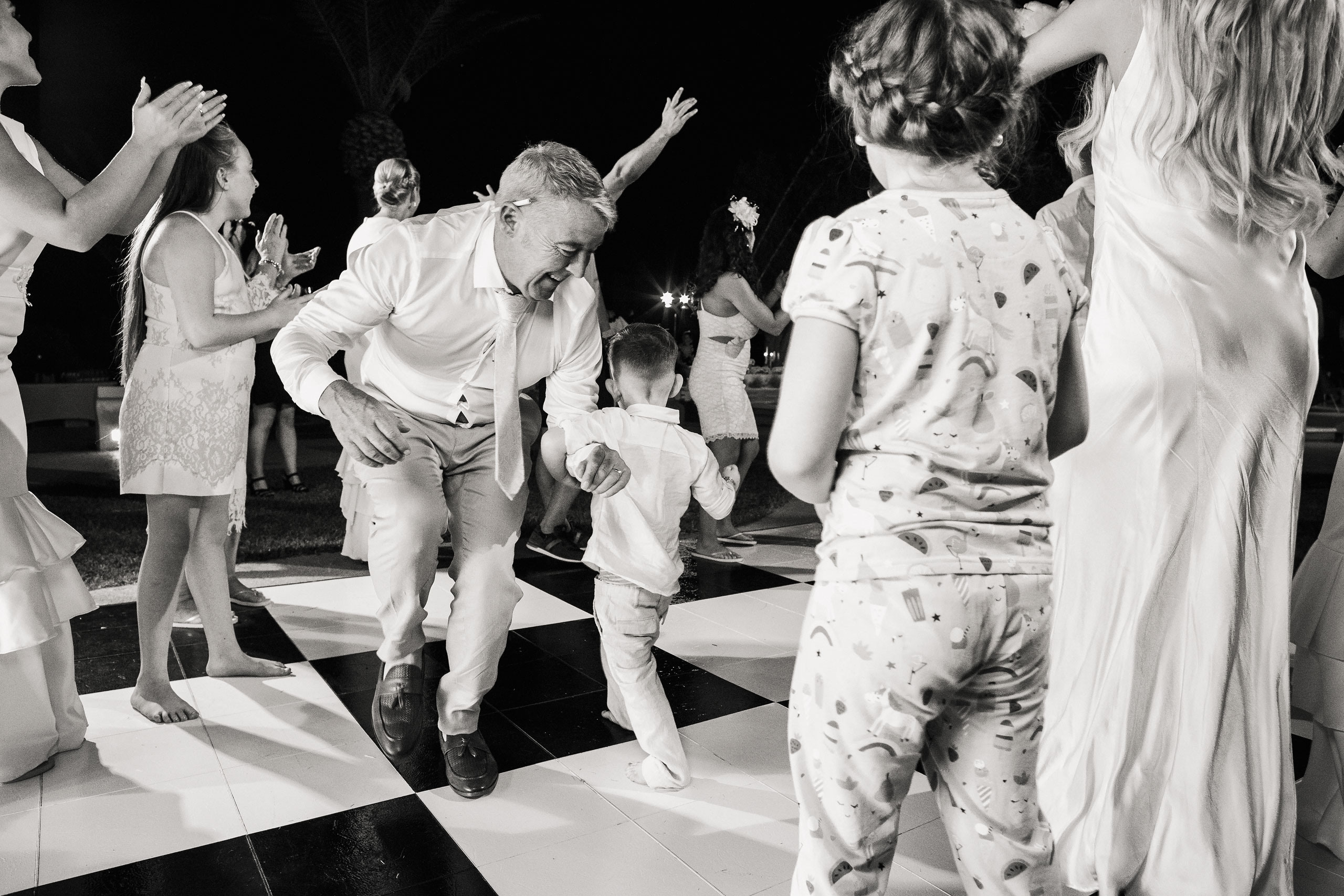 girl and boy are dancing with the old man on a wedding party