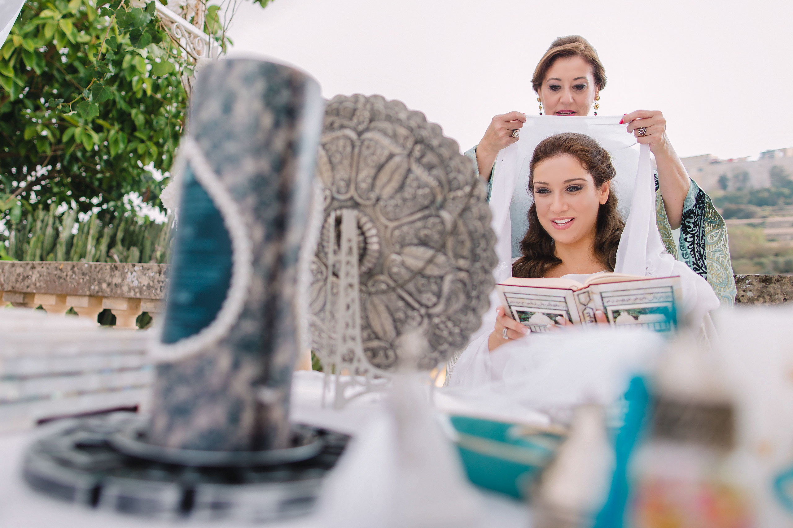 Arabic wedding ceremony, bride in a white dress looking in the mirror smiling happily