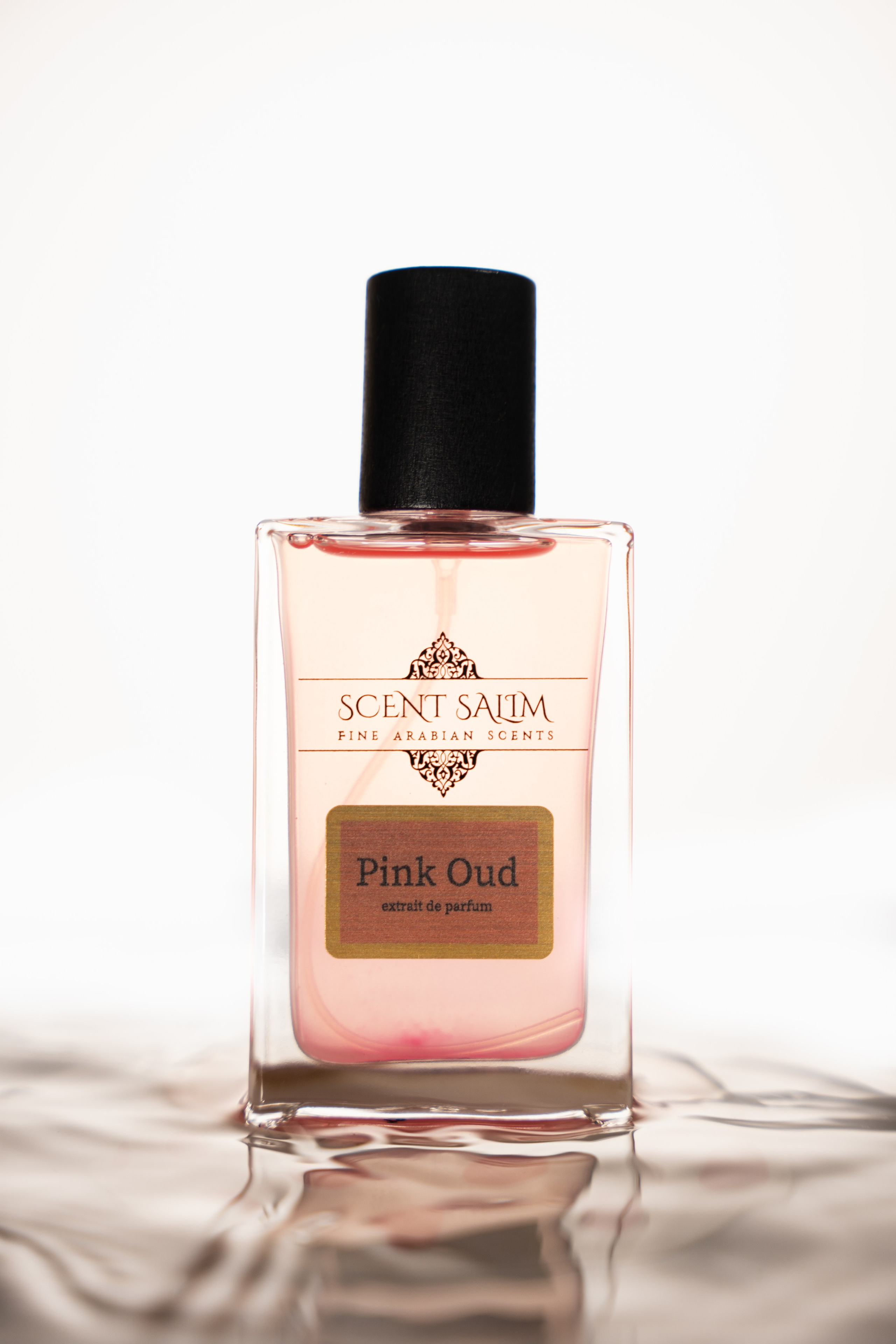 Elegant pink perfume bottle on white background — beauty fragrance product shot London.