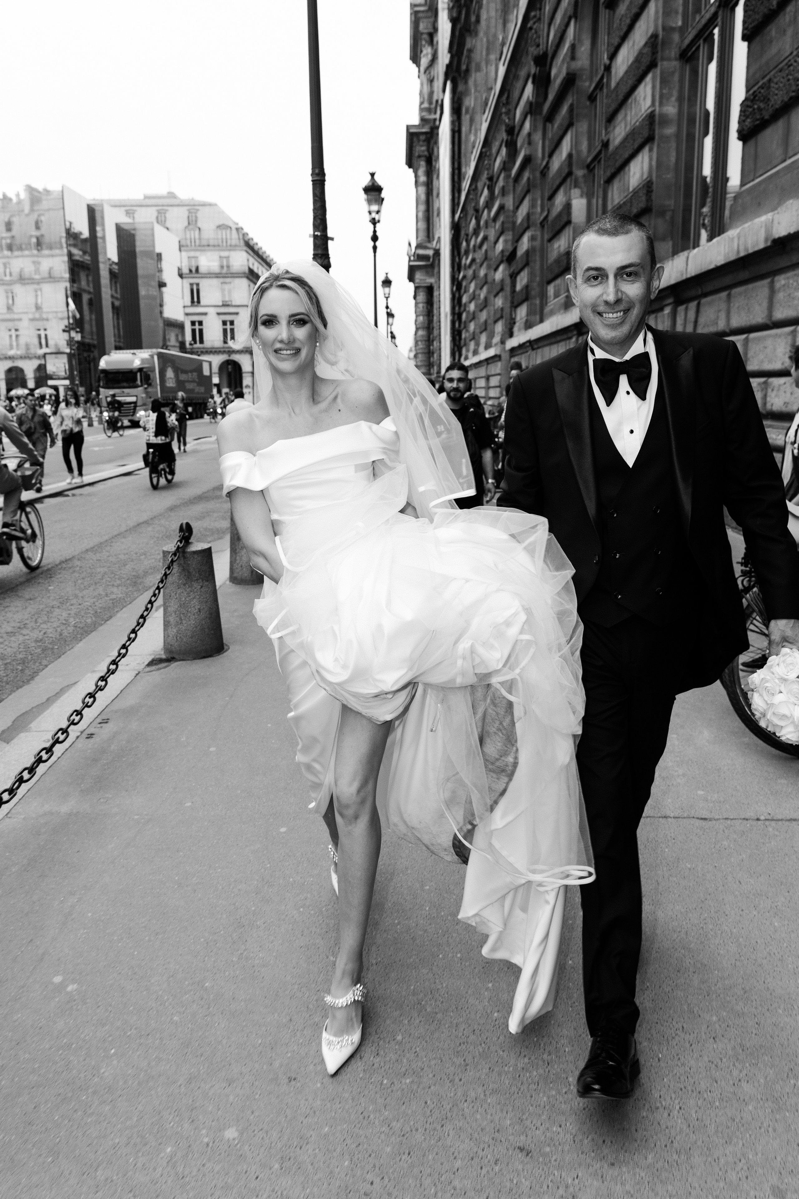 Bride and groom walking through the streets of Paris after their wedding ceremony, elegant Paris destination wedding photography in black and white
