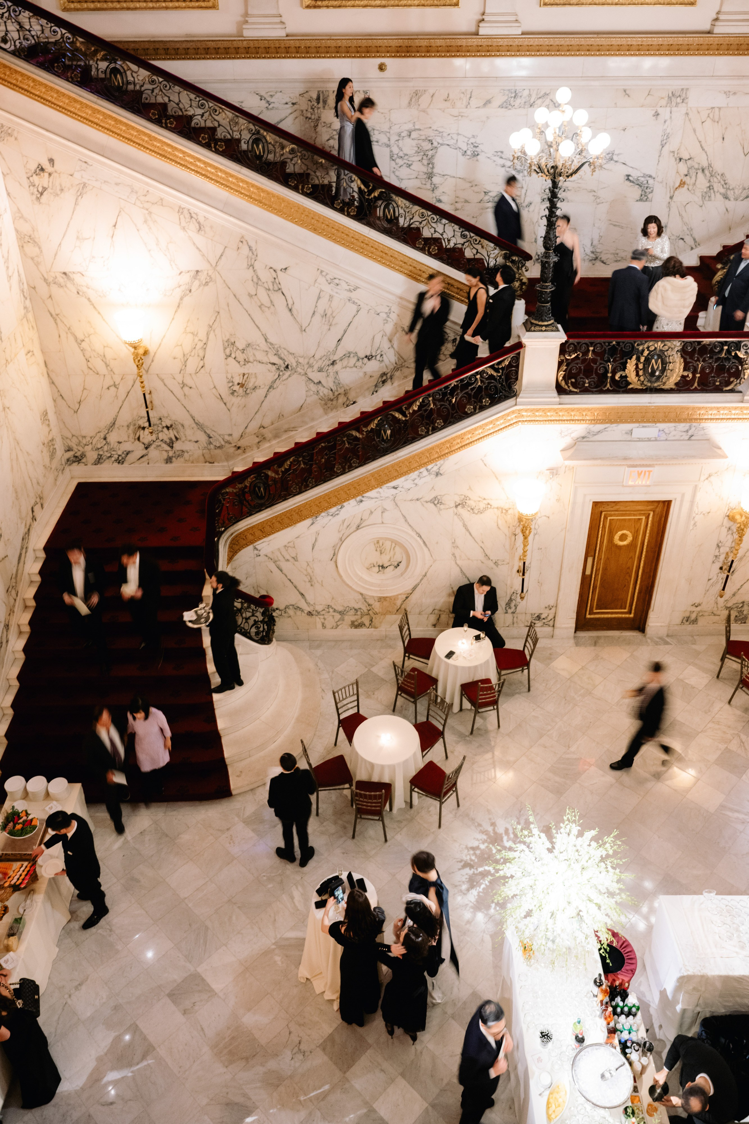 a group of people standing around a staircase