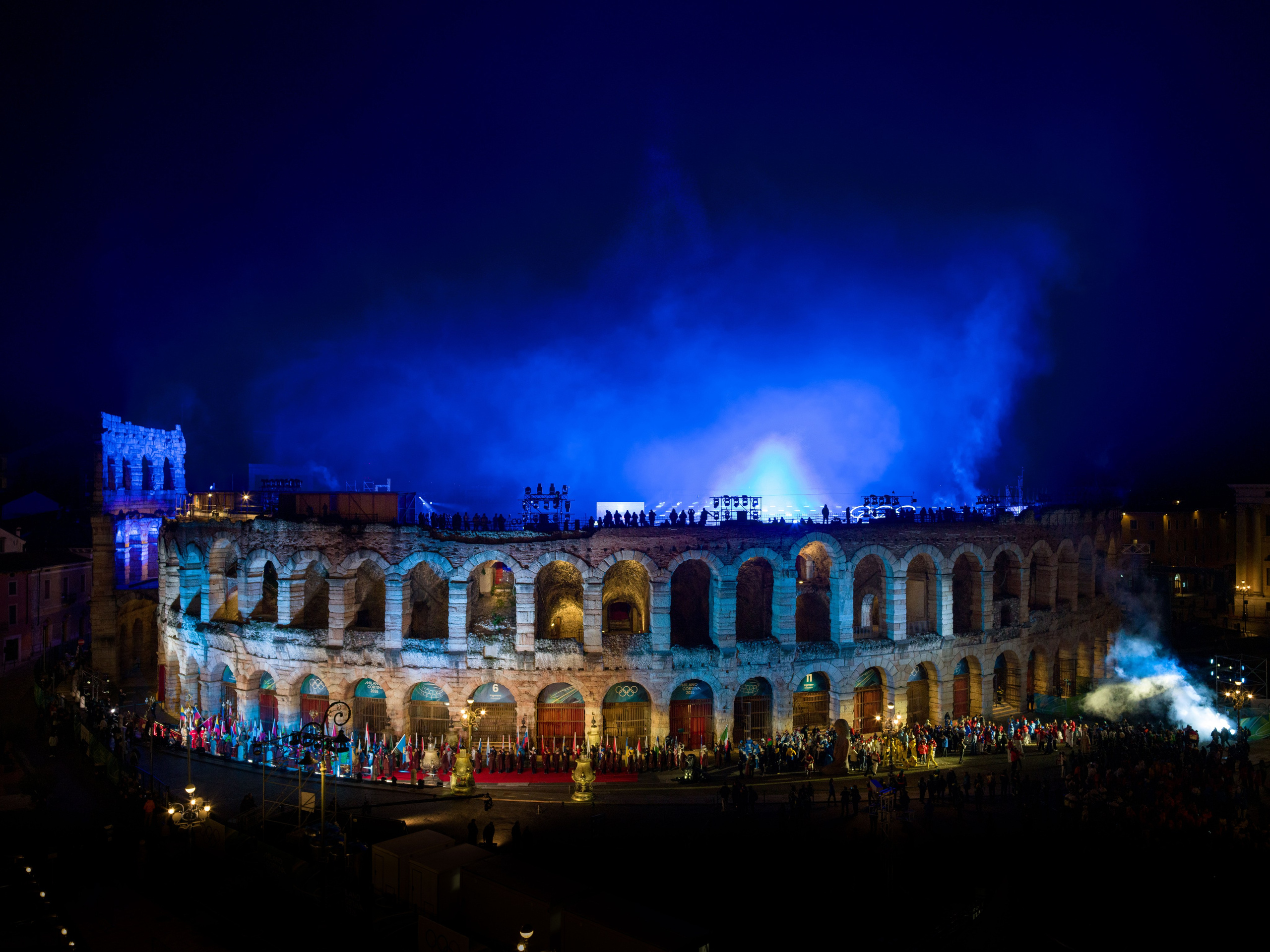 Historic night photography of Arena di Verona during the Winter Olympic closing ceremony. A once-in-history moment captured as fine art. Available as premium wall art and collectible print.