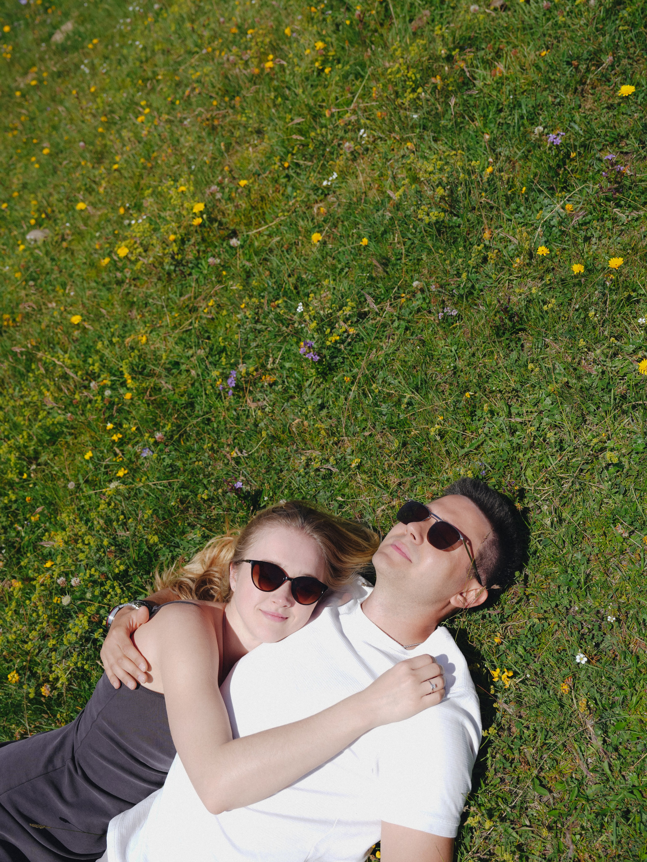 Couple laying in the alpine fields, Kazbegi