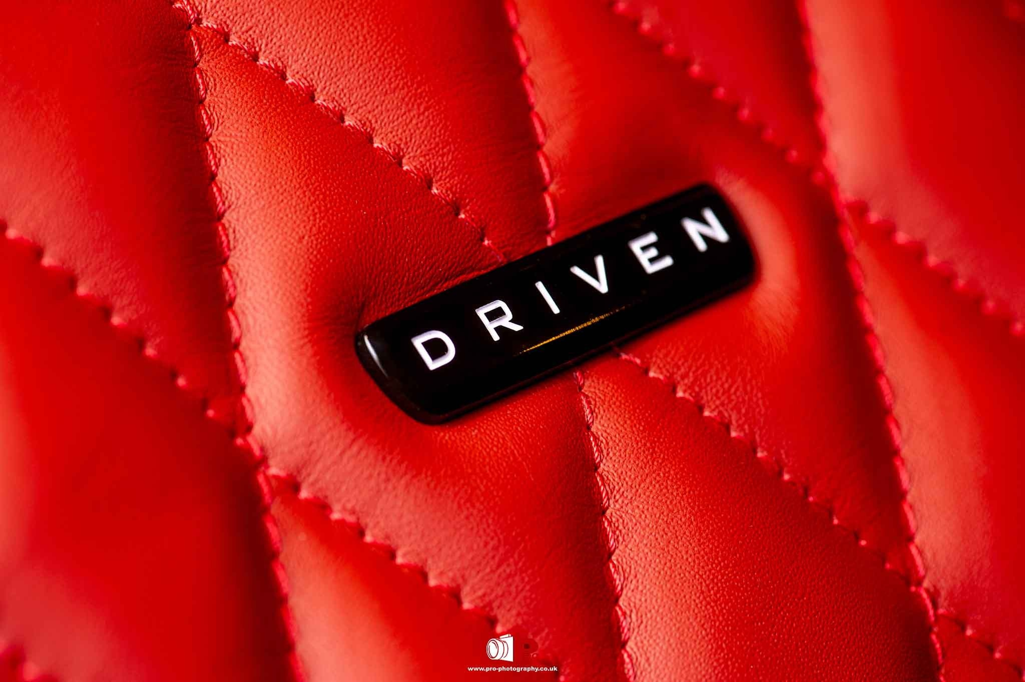 Lifestyle detail image of passengers seated inside a luxury vehicle with a premium leather interior.