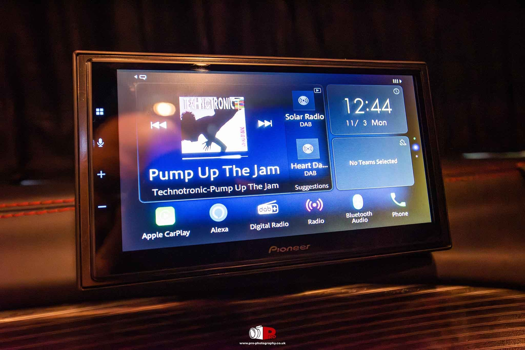 Close-up of a Pioneer in-car multimedia screen displaying digital radio and entertainment controls.