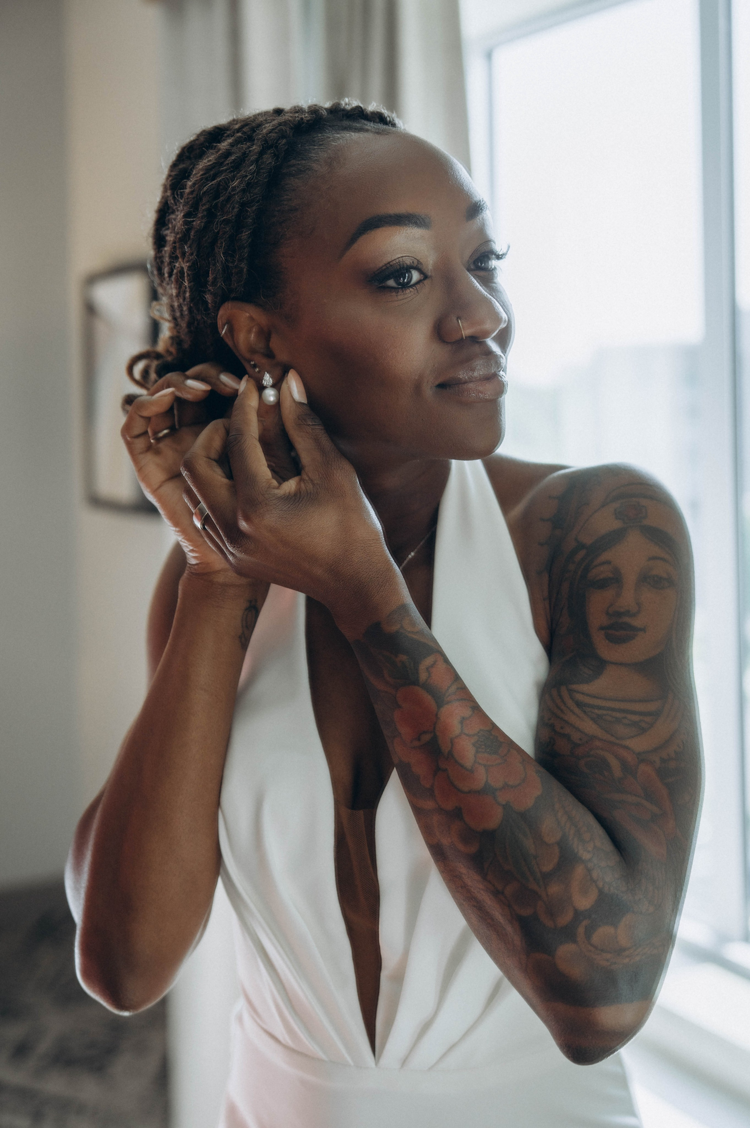Bride walking along Sacandaga Lake beach in sunlight.