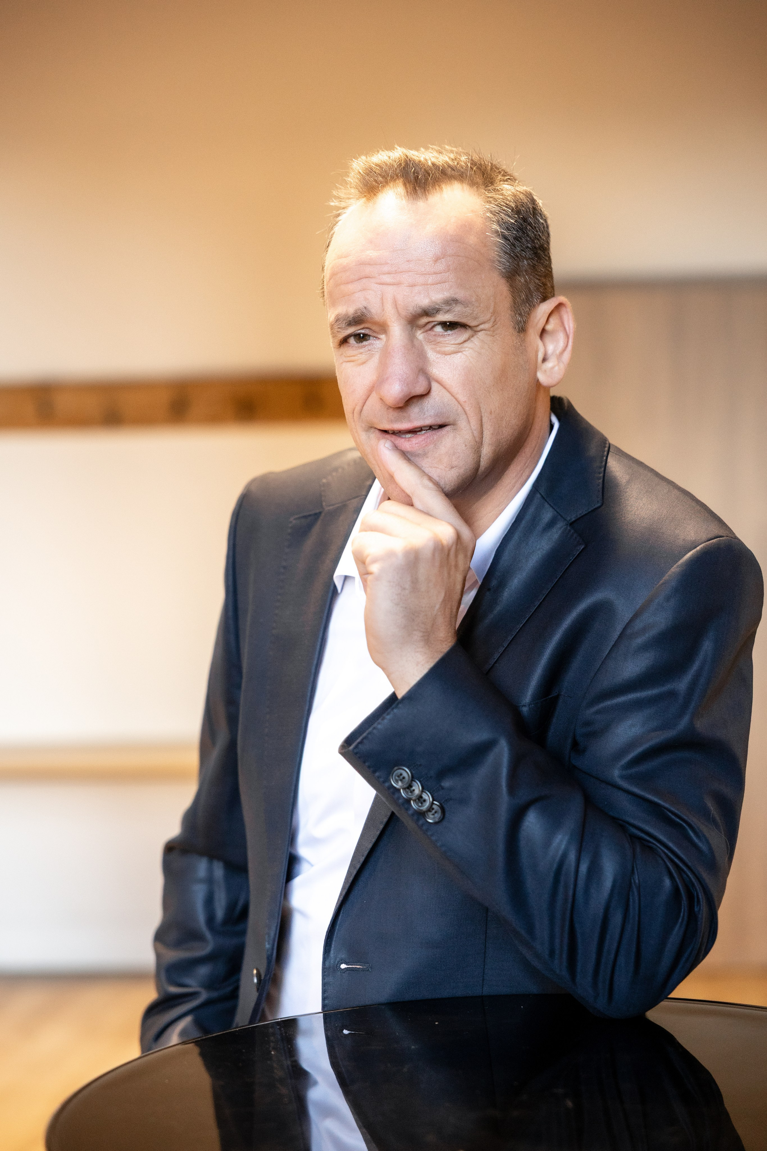 Сorporate portrait of a business leader in an office setting, personal branding photography for executive use.