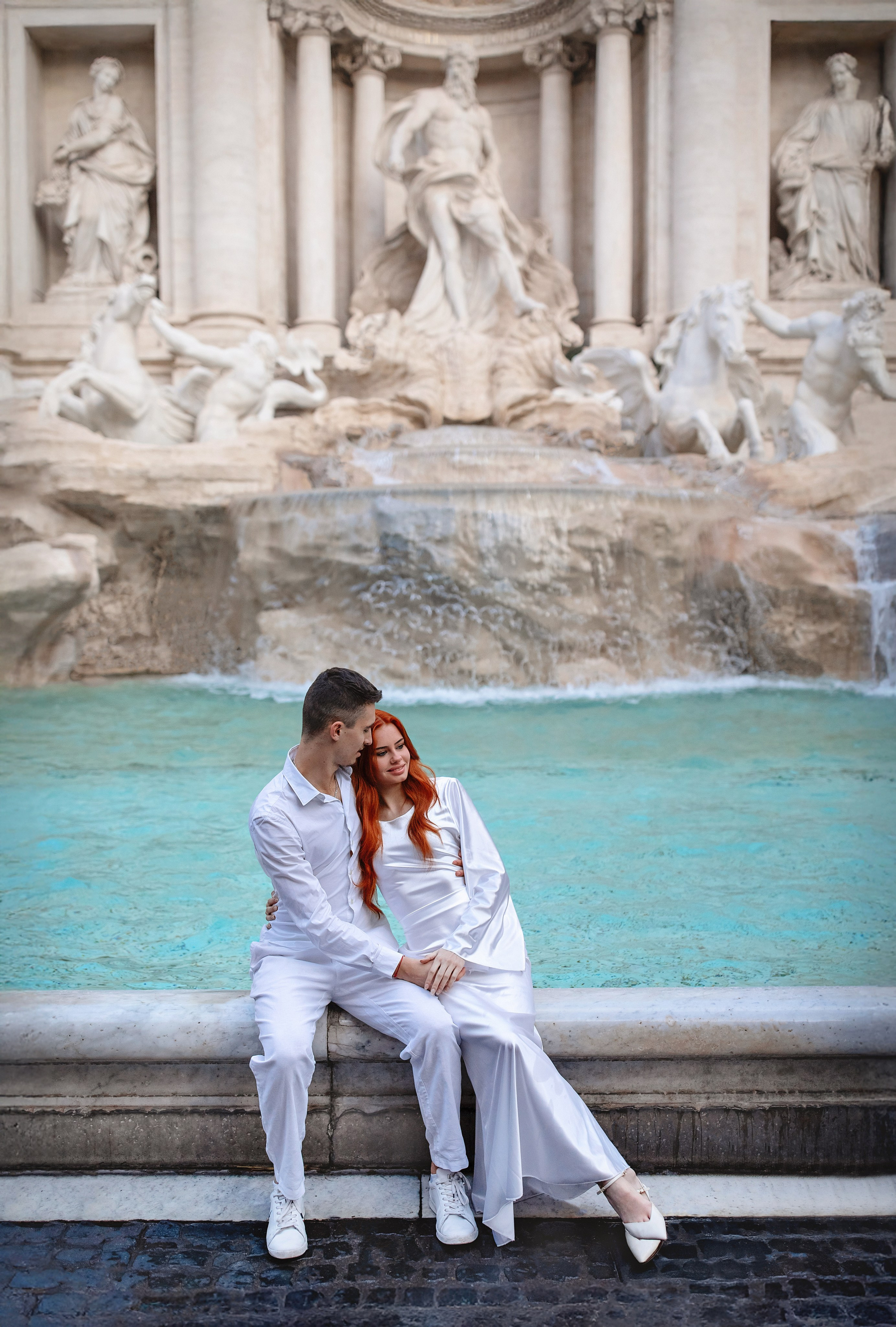 Romantic couple at the Trevi Fountain during a photoshoot in Rome