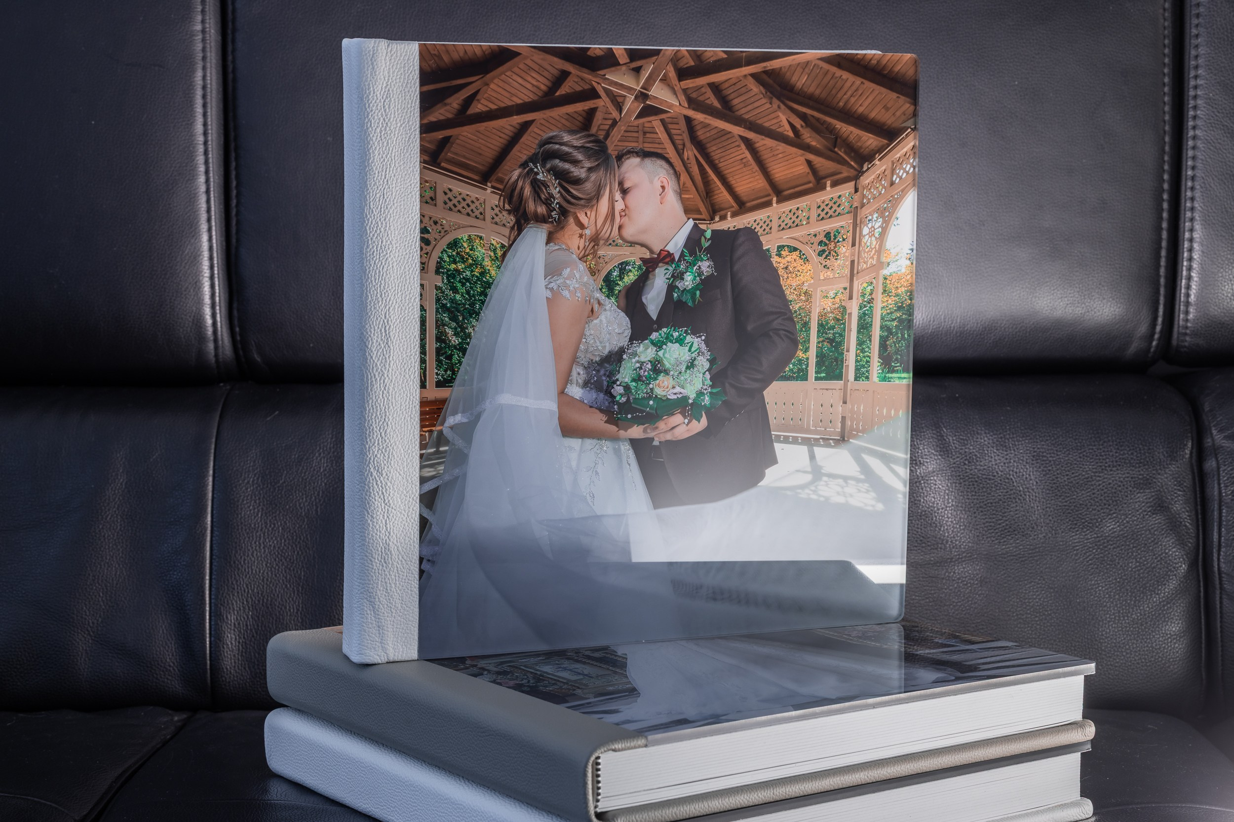 Premium-Fotoalbum mit Einband aus hellbeigem Naturleder und transparenter Acrylglas-Deckplatte, Layflat-Bindung mit Metallspirale. Ideales Hochzeits- oder Familienalbum der Luxusklasse. Hochwertige Verarbeitung, dicke Seiten mit silbernem Schnitt. Perfekt für exklusive Fotobücher.