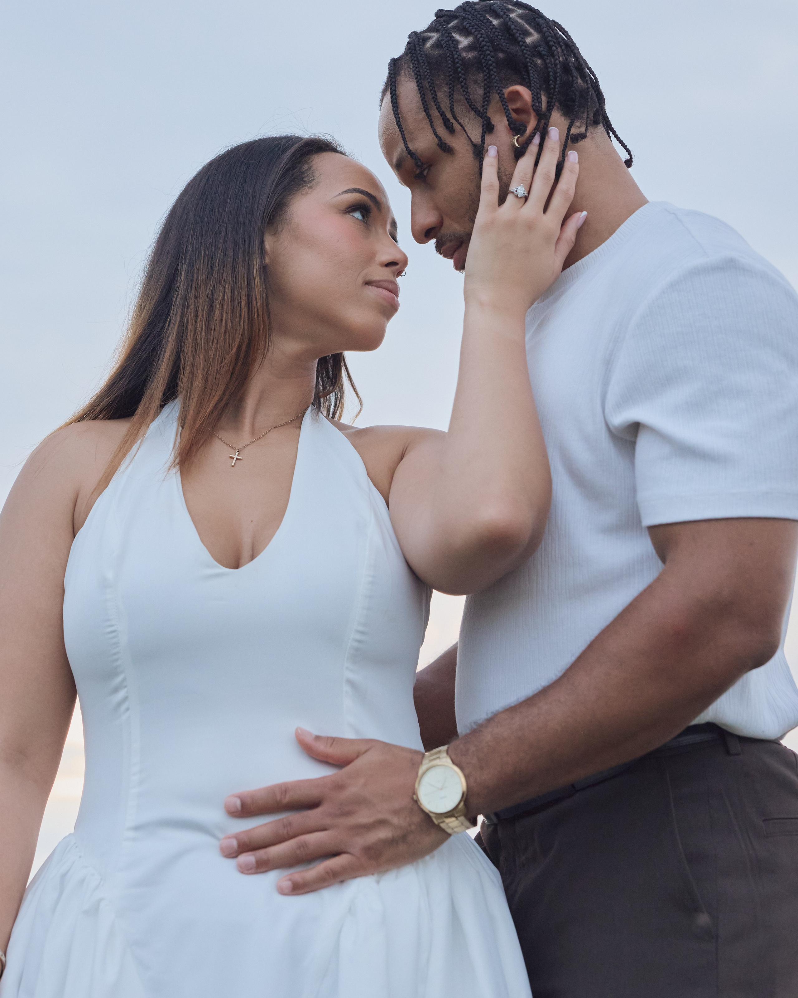 Her hand gently on his face in a tender engagement portrait at Alum Creek