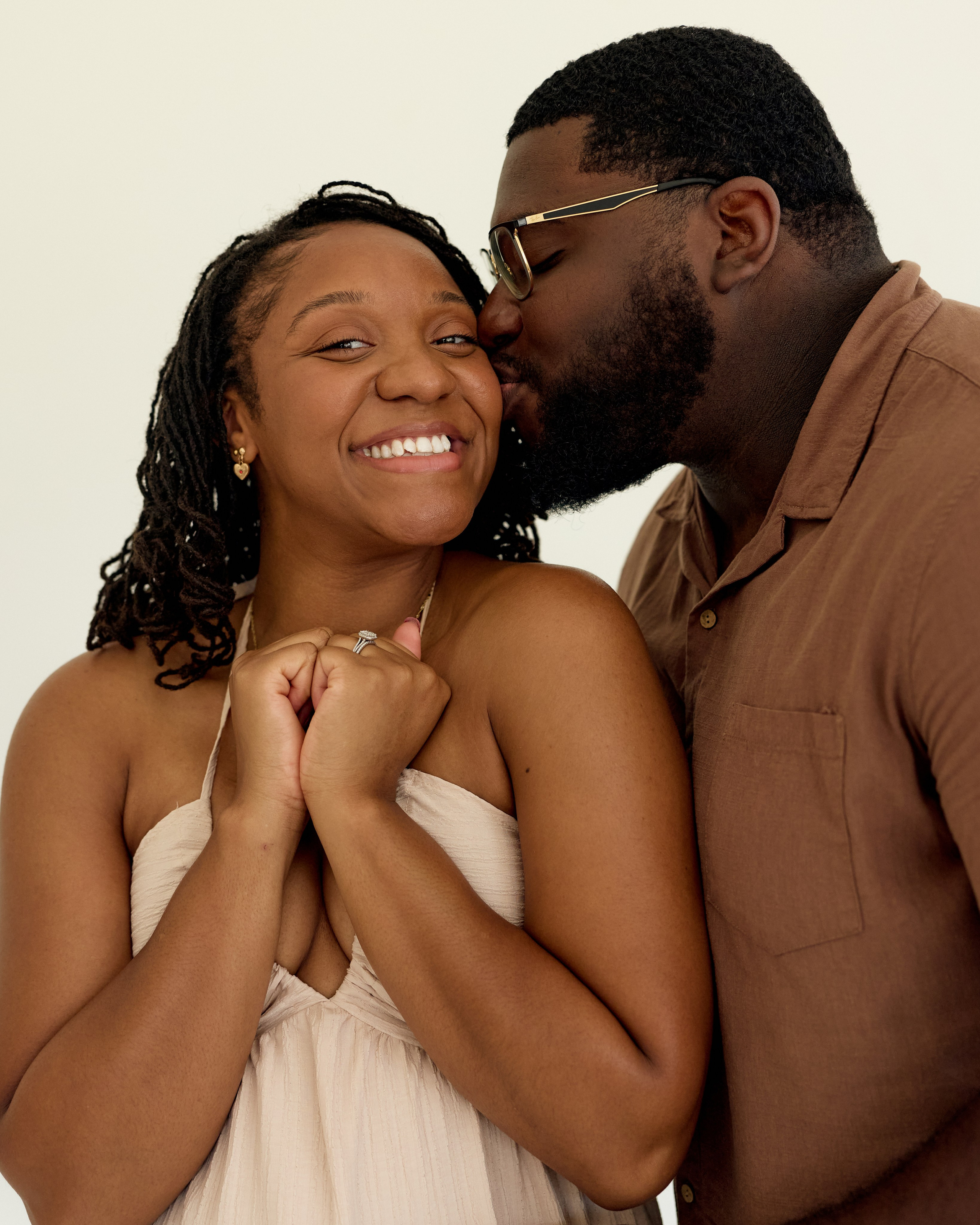 Kiss on the cheek during a studio engagement session in Columbus, Ohio