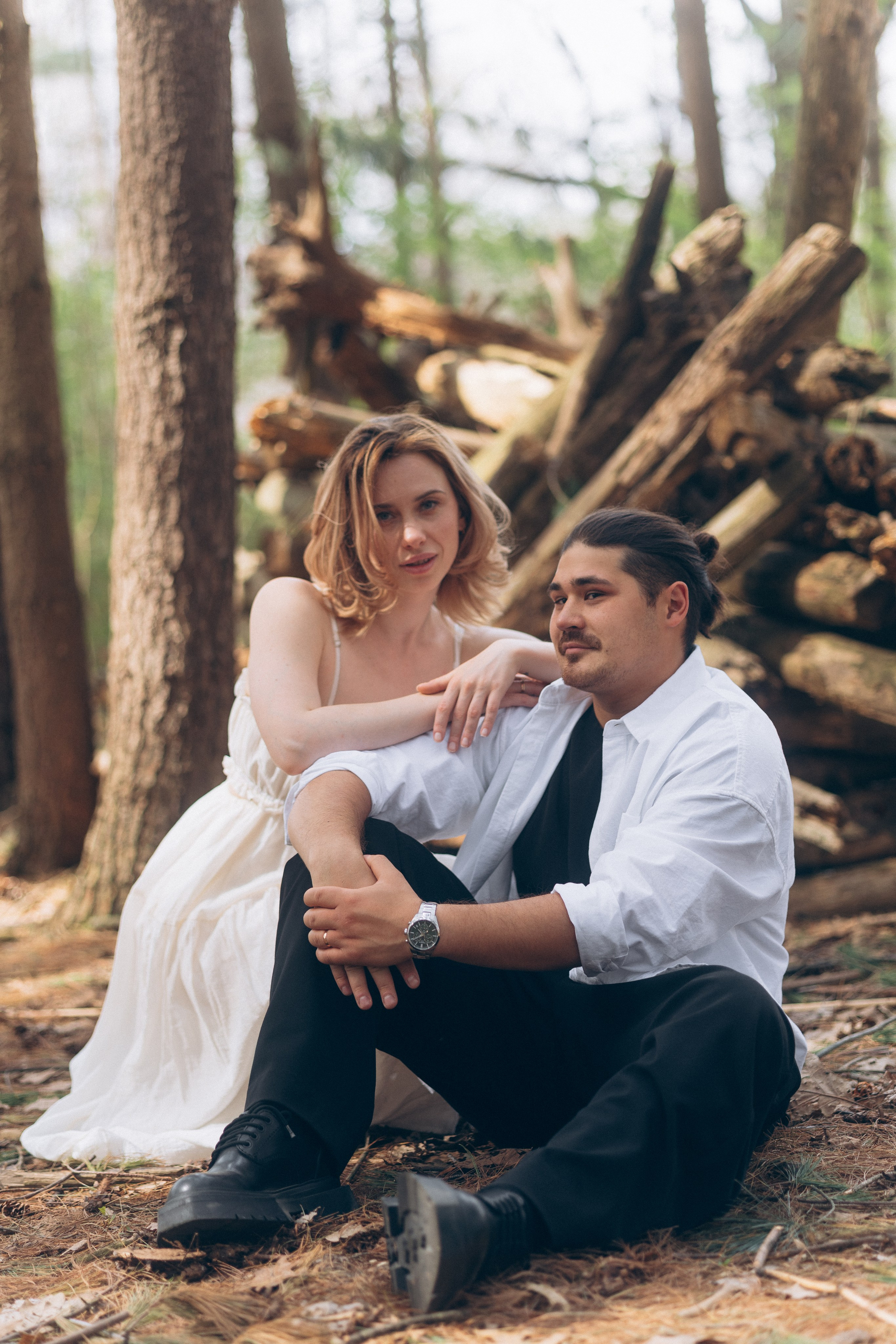 Couple sitting among fallen logs in the woods near Hoover Dam, Ohio