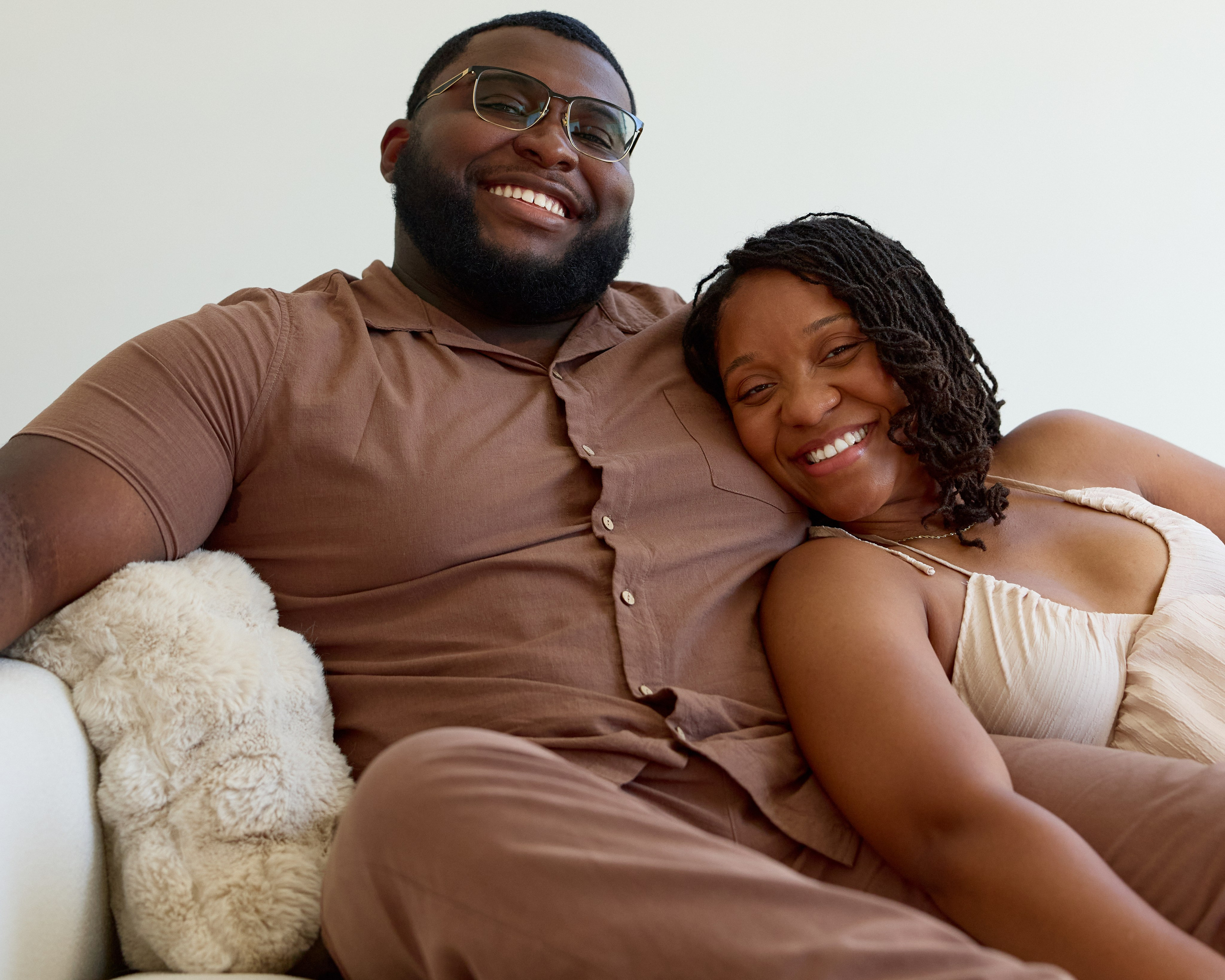 Cuddled up on a couch in a bright Columbus photography studio