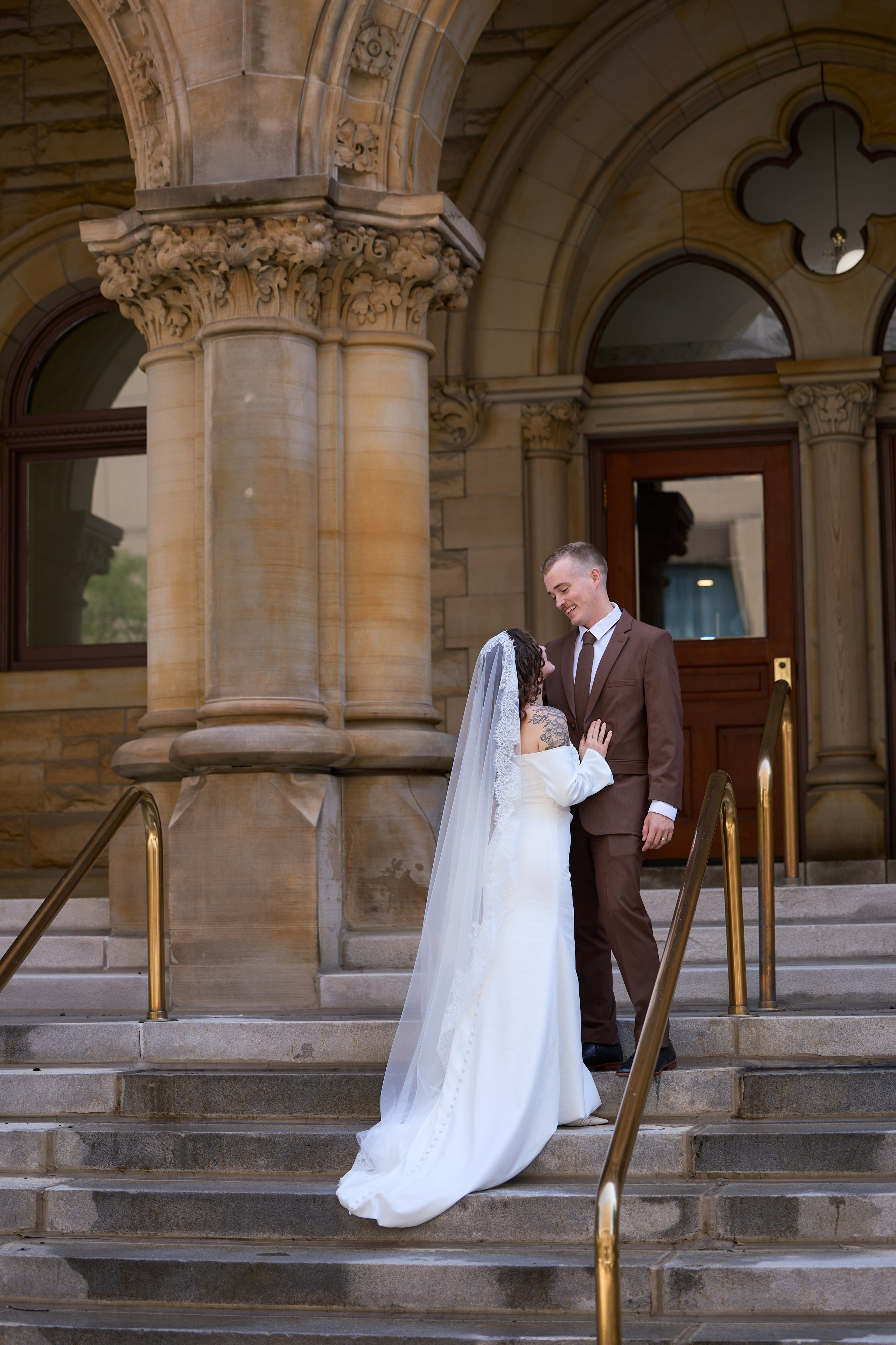 Embrace on the stairs of a landmark building in downtown Columbus, Ohio