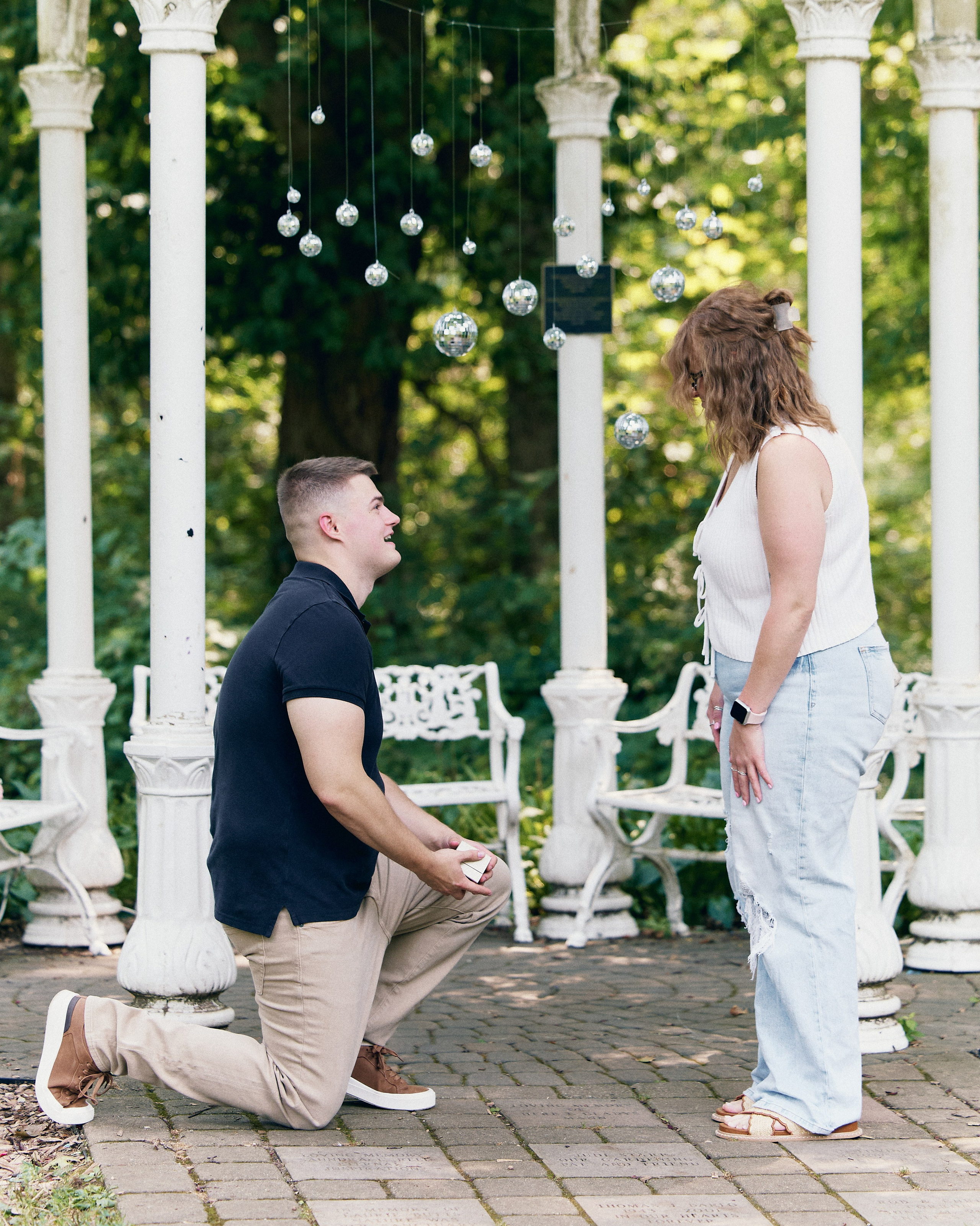 Proposal under a pergola with hanging lights in Columbus, Ohio