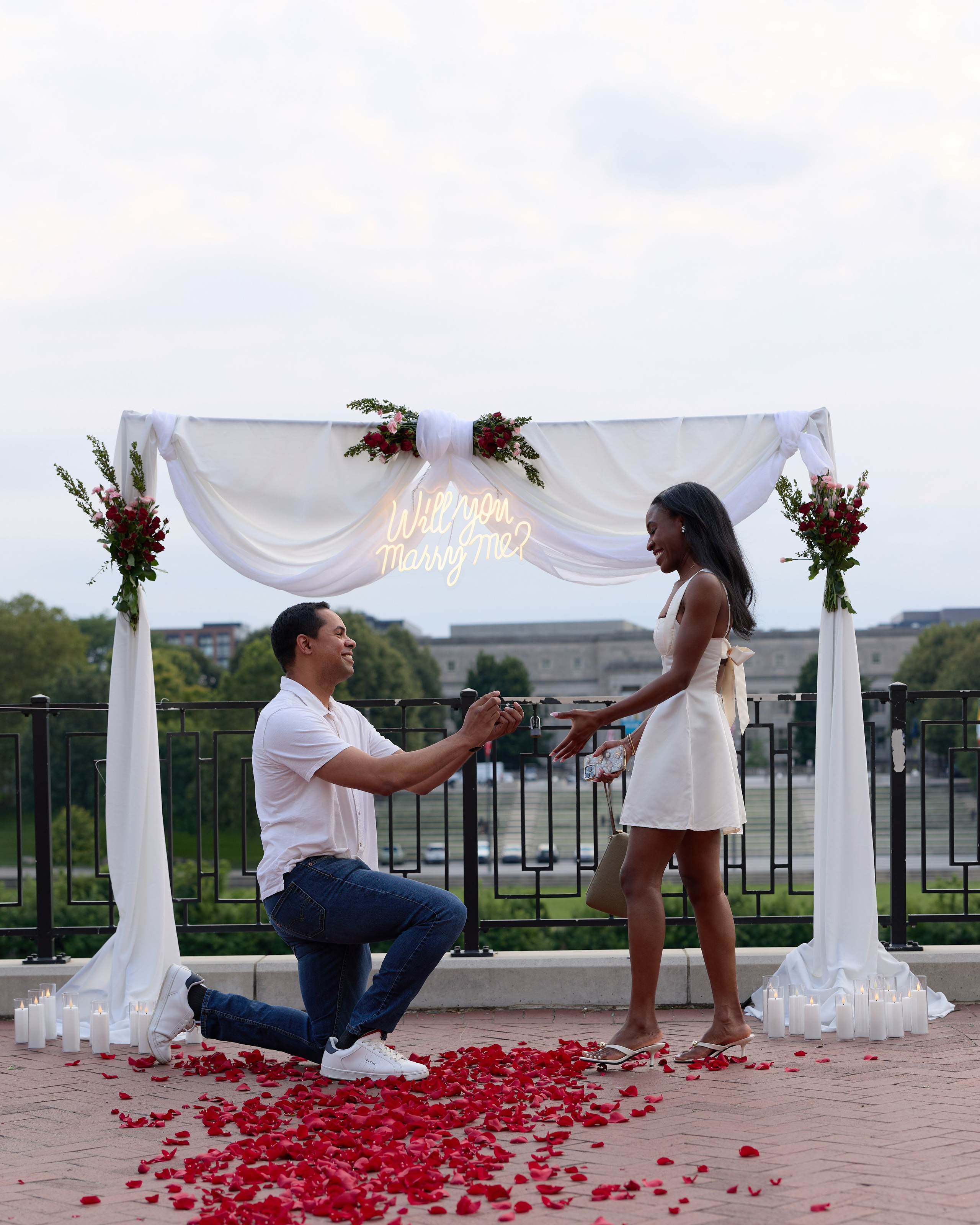 Proposal under a flower arch with rose petals in Columbus, Ohio