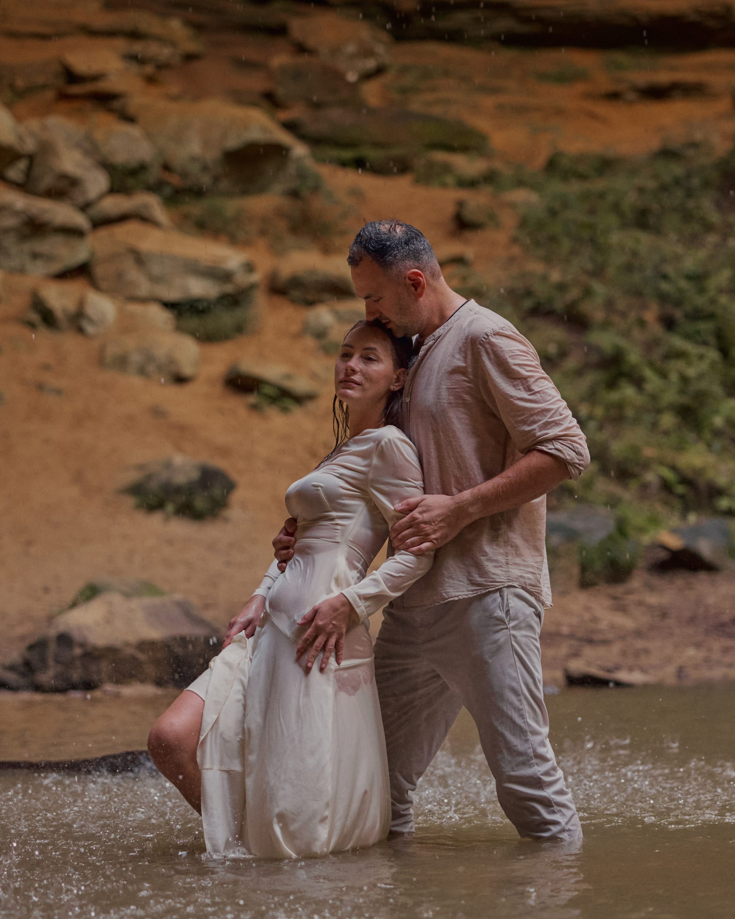 Couple standing together in the rocky stream at Ash Cave, Ohio