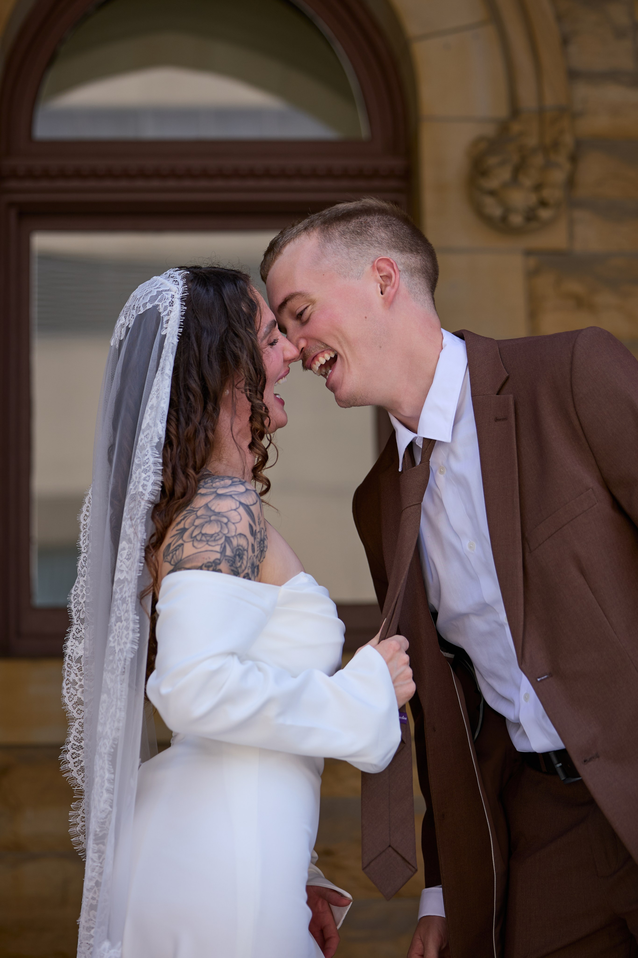 Tender pose by an arched doorway at a historic Columbus building