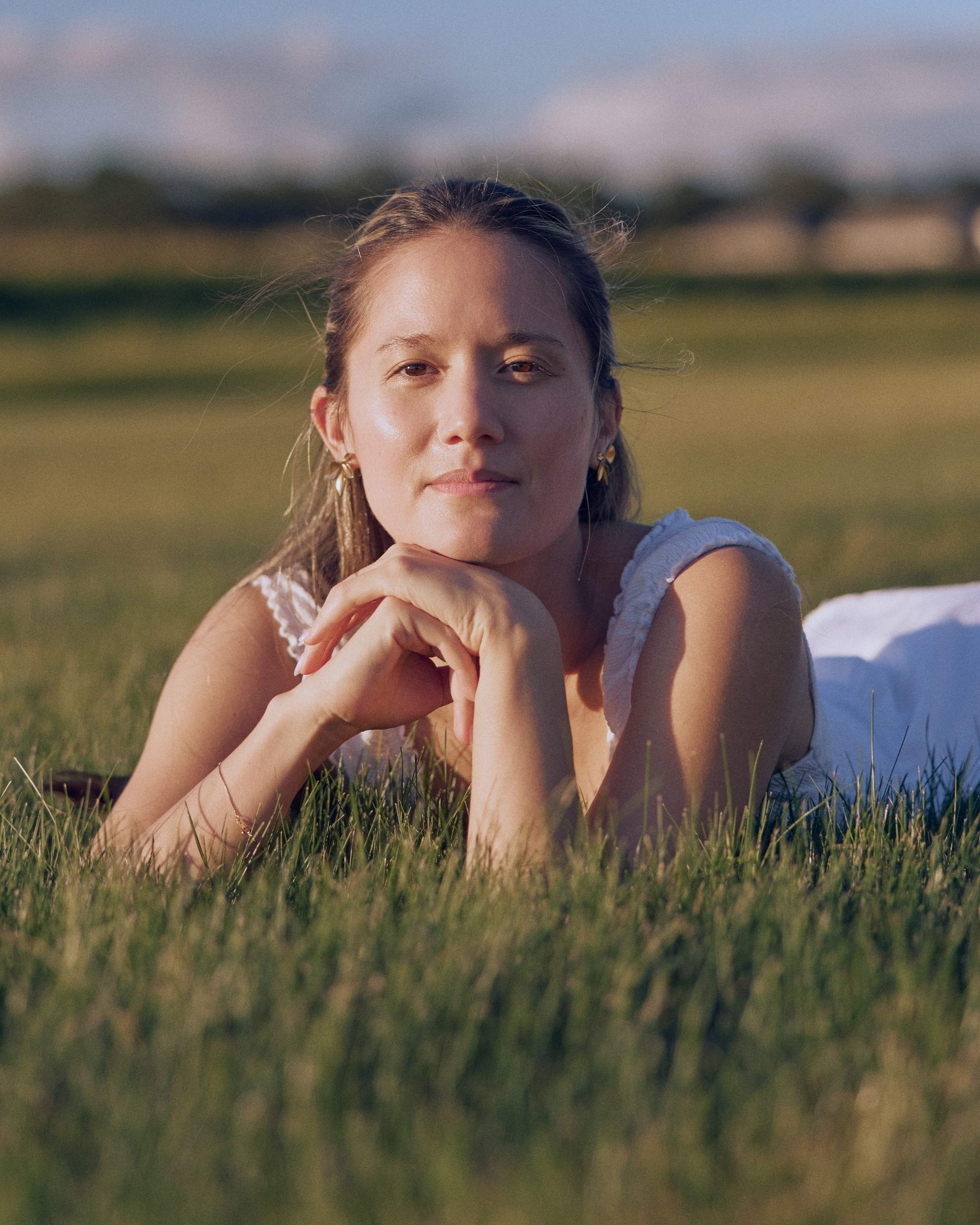 Bride-to-be lying in the grass in a dreamy portrait near Columbus, Ohio