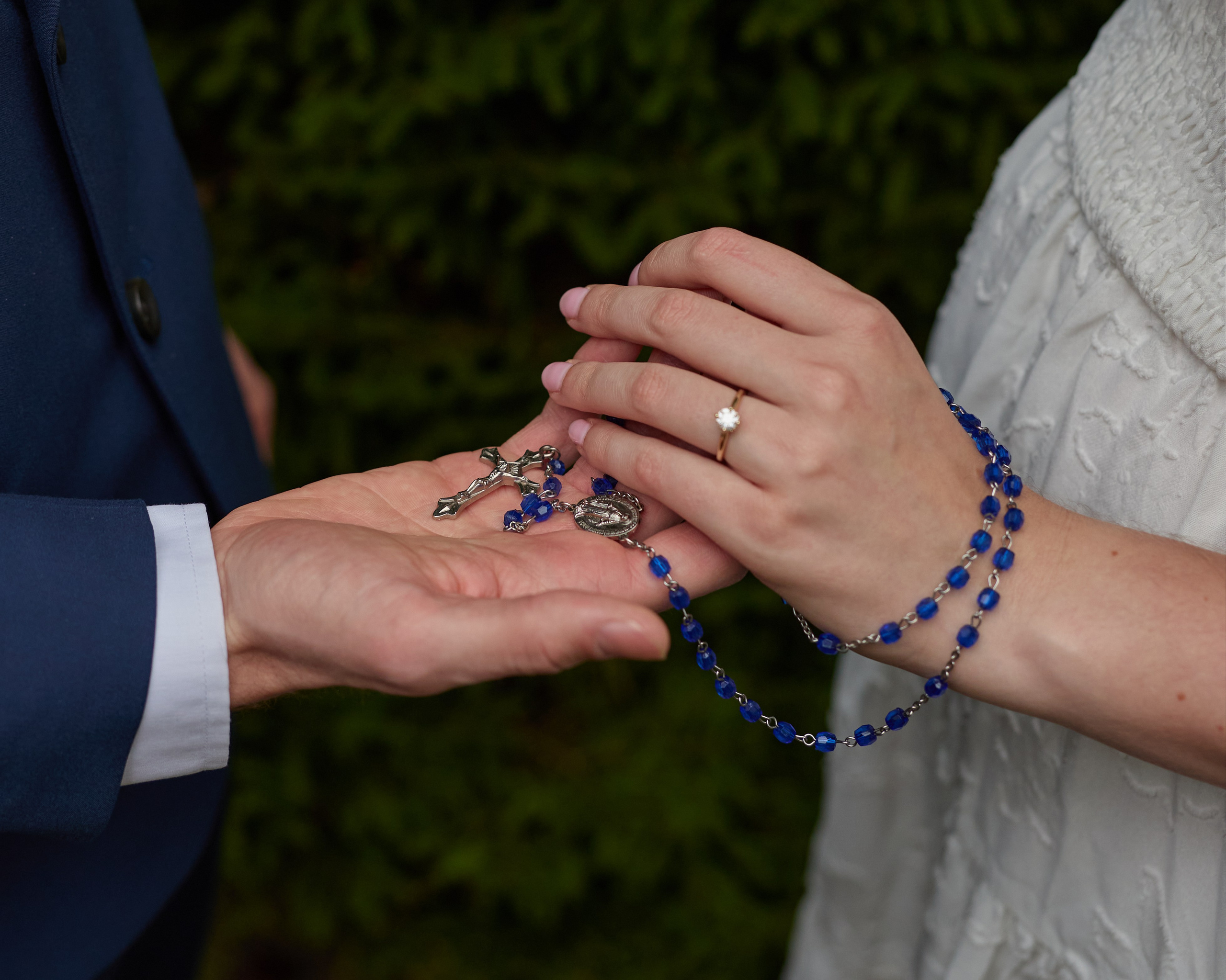 Hands exchanging a rosary with the engagement ring visible, Inniswood Ohio