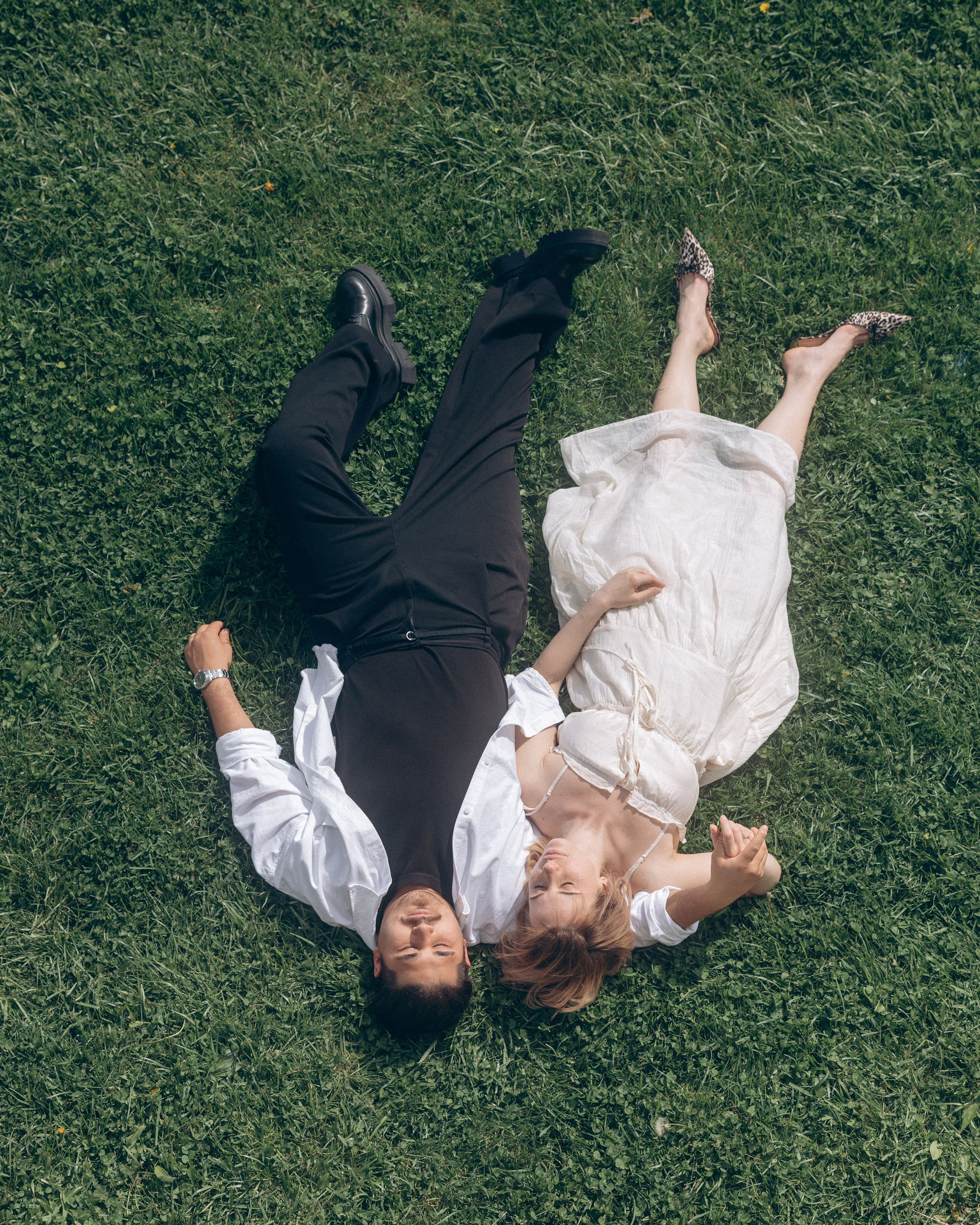 Top-down shot of an engaged couple on a green lawn in Ohio
