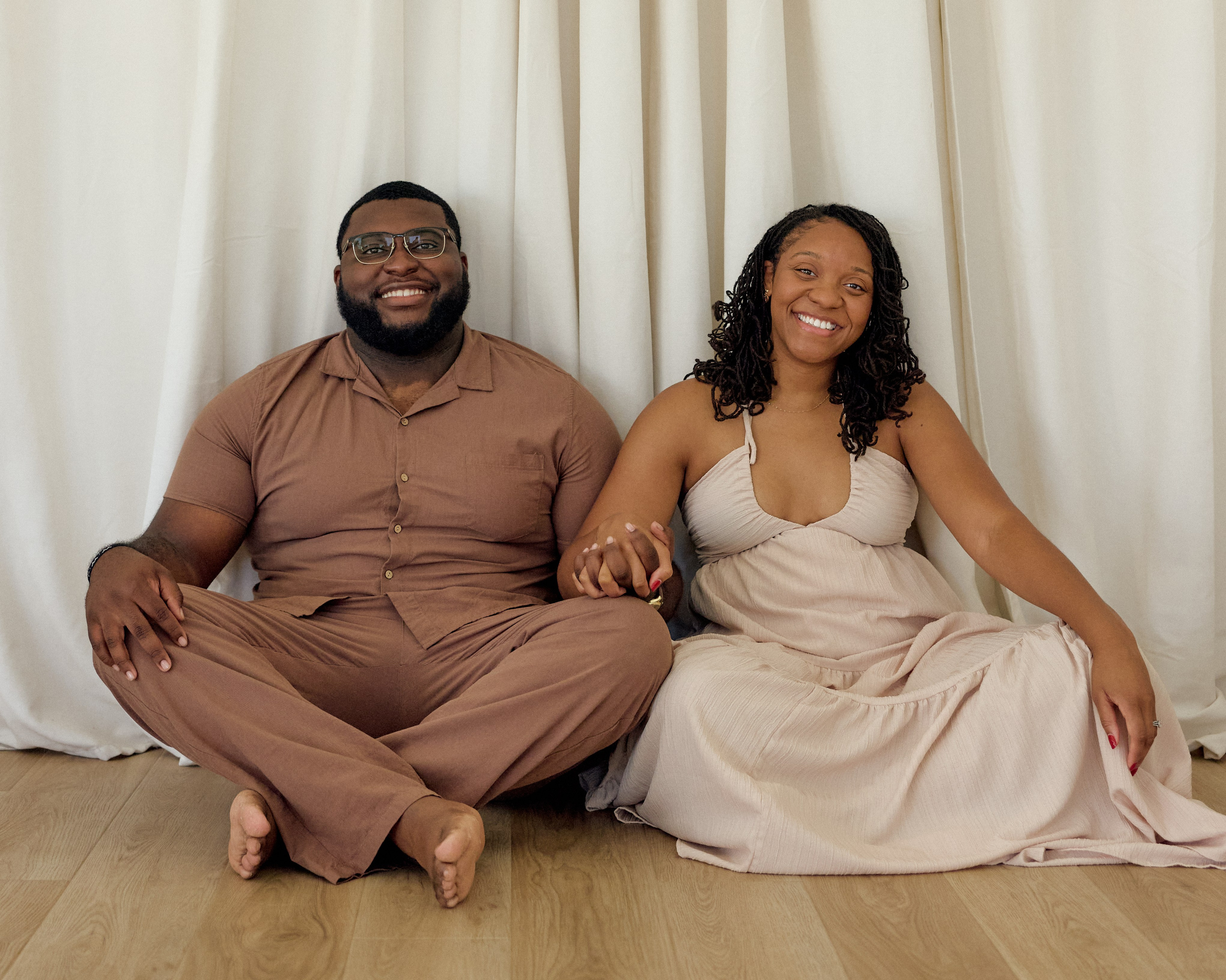 Sitting cross-legged together on a studio floor in Columbus, Ohio