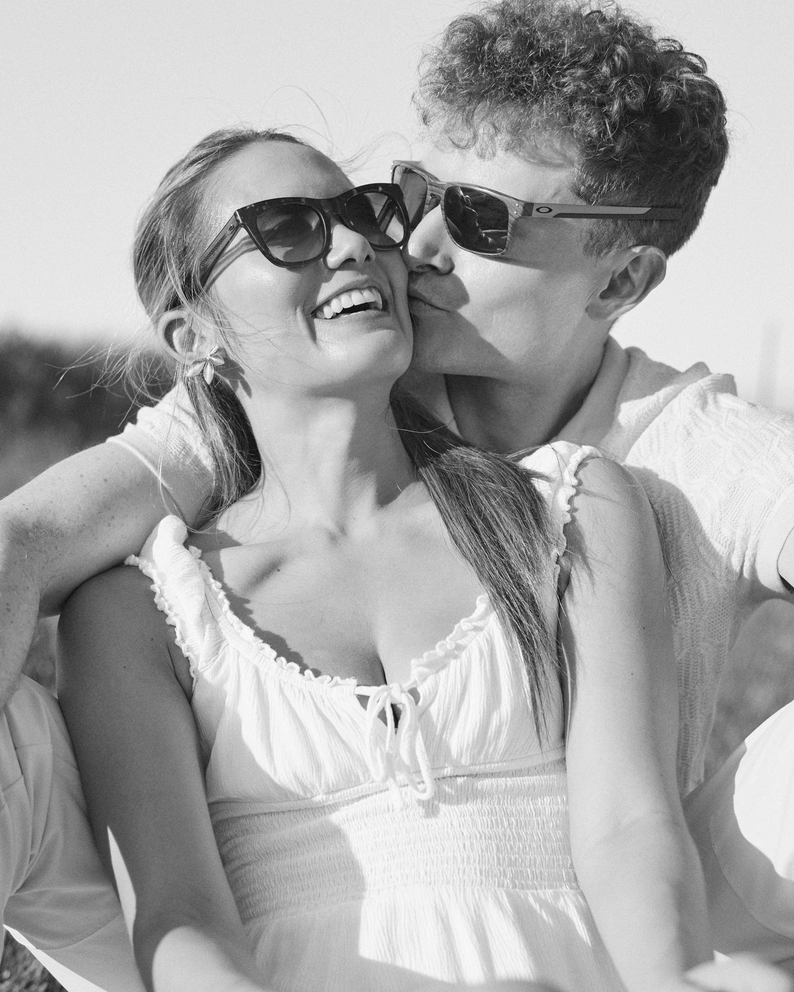 Black and white photo of a kiss on the cheek during a field session in Ohio