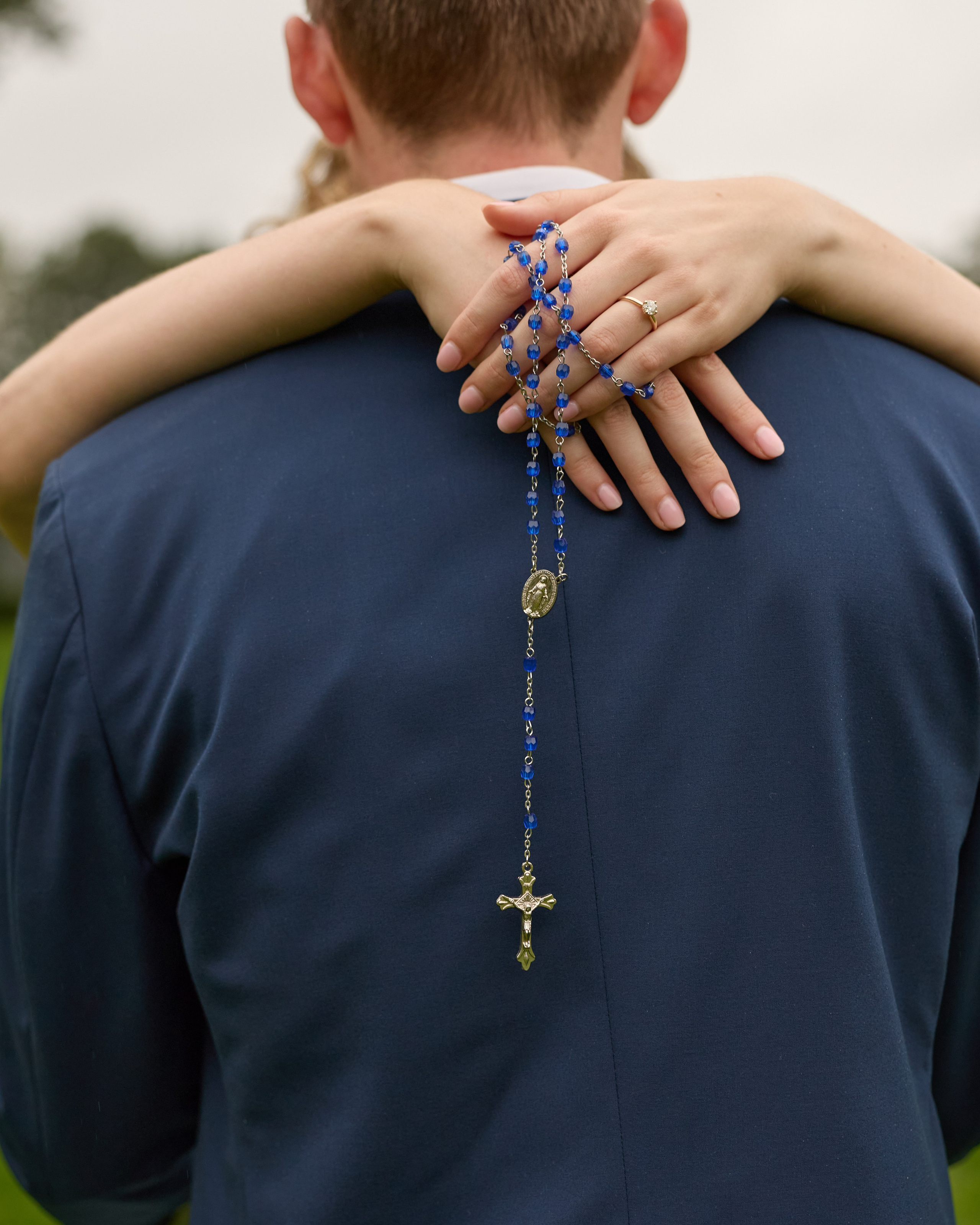 Embrace from behind with a rosary in her hands at Inniswood Metro Gardens, Ohio
