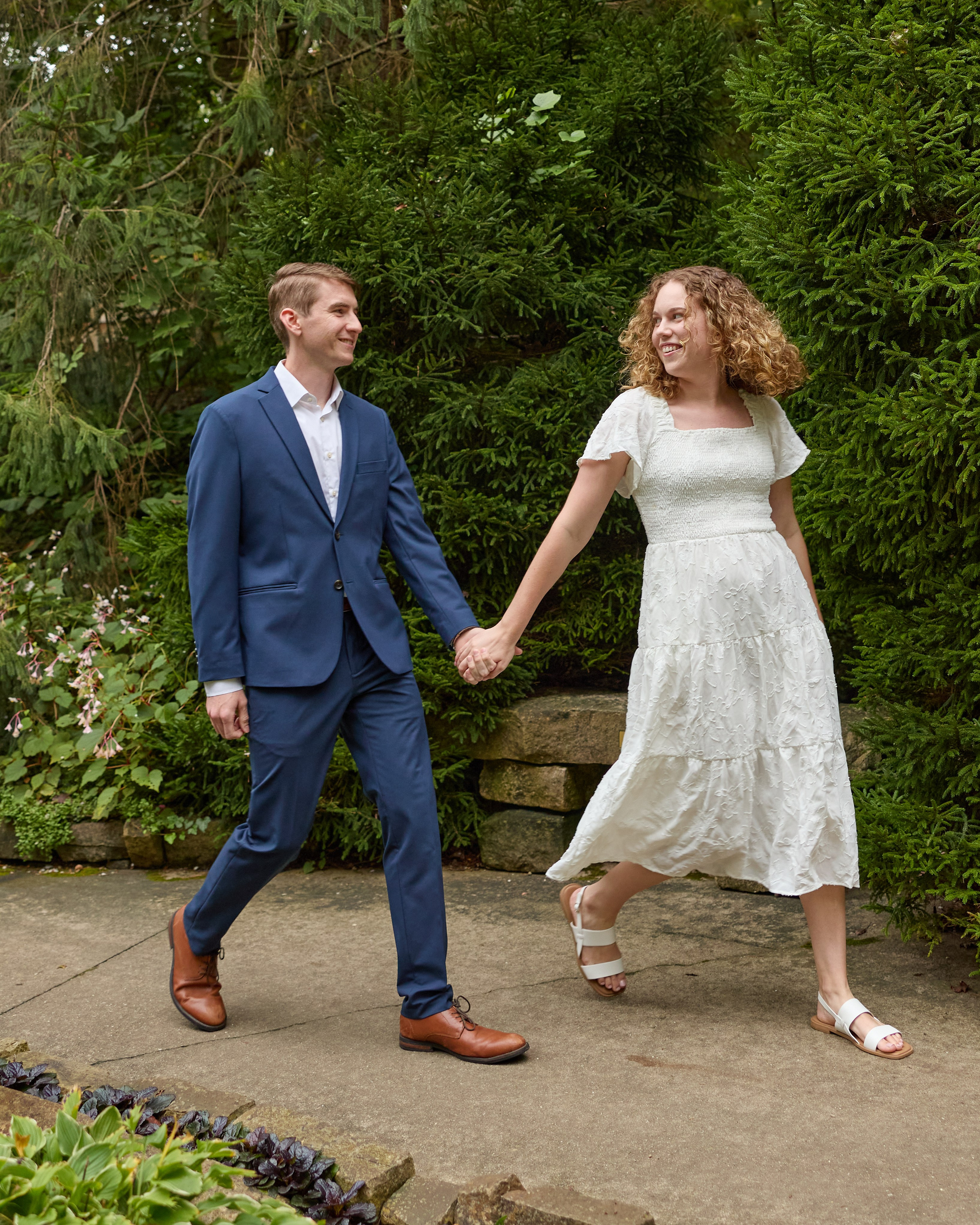 Couple walking hand in hand along a garden path at Inniswood near Columbus