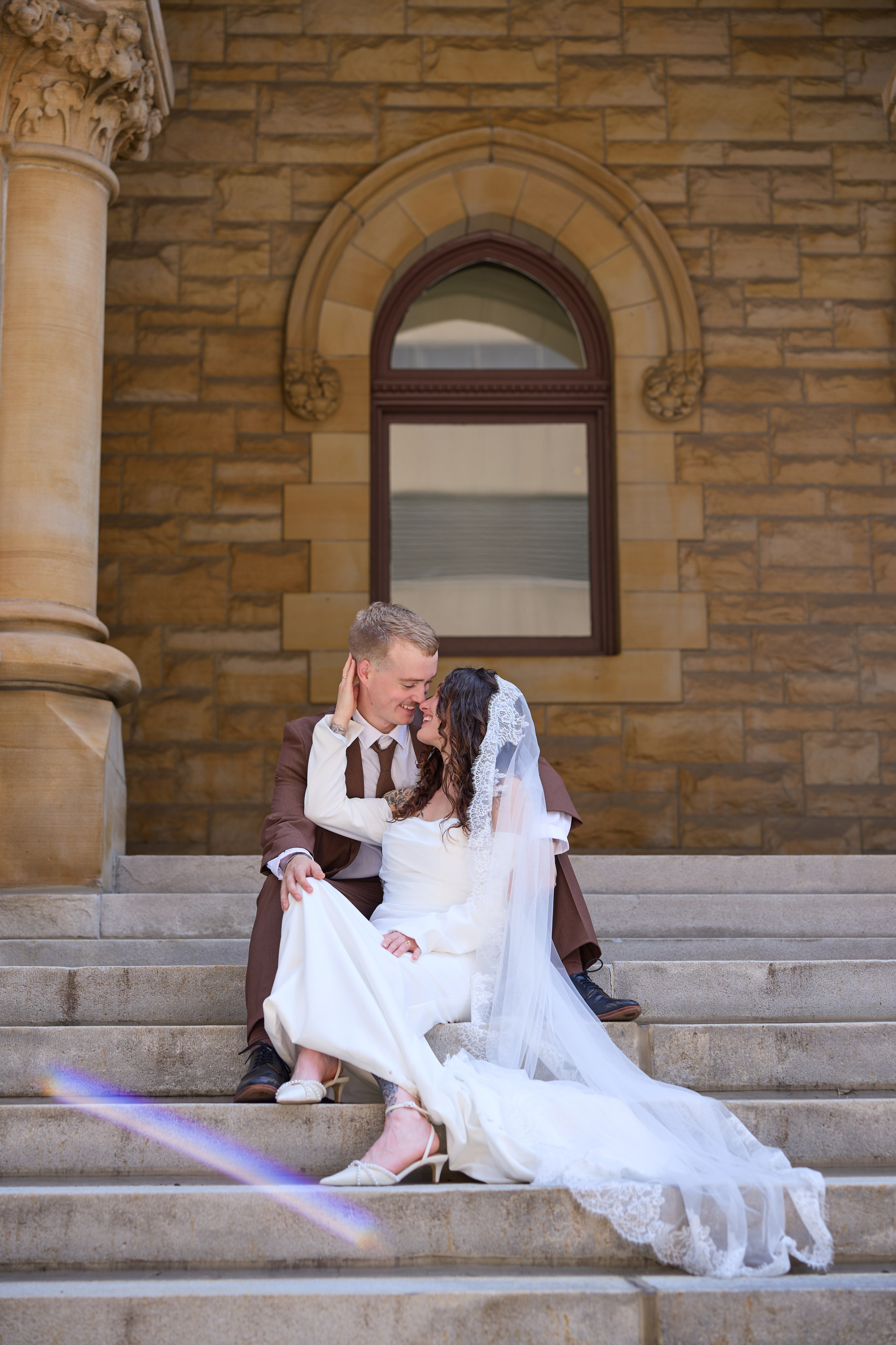 Couple sitting together on worn stone steps in downtown Columbus, Ohio