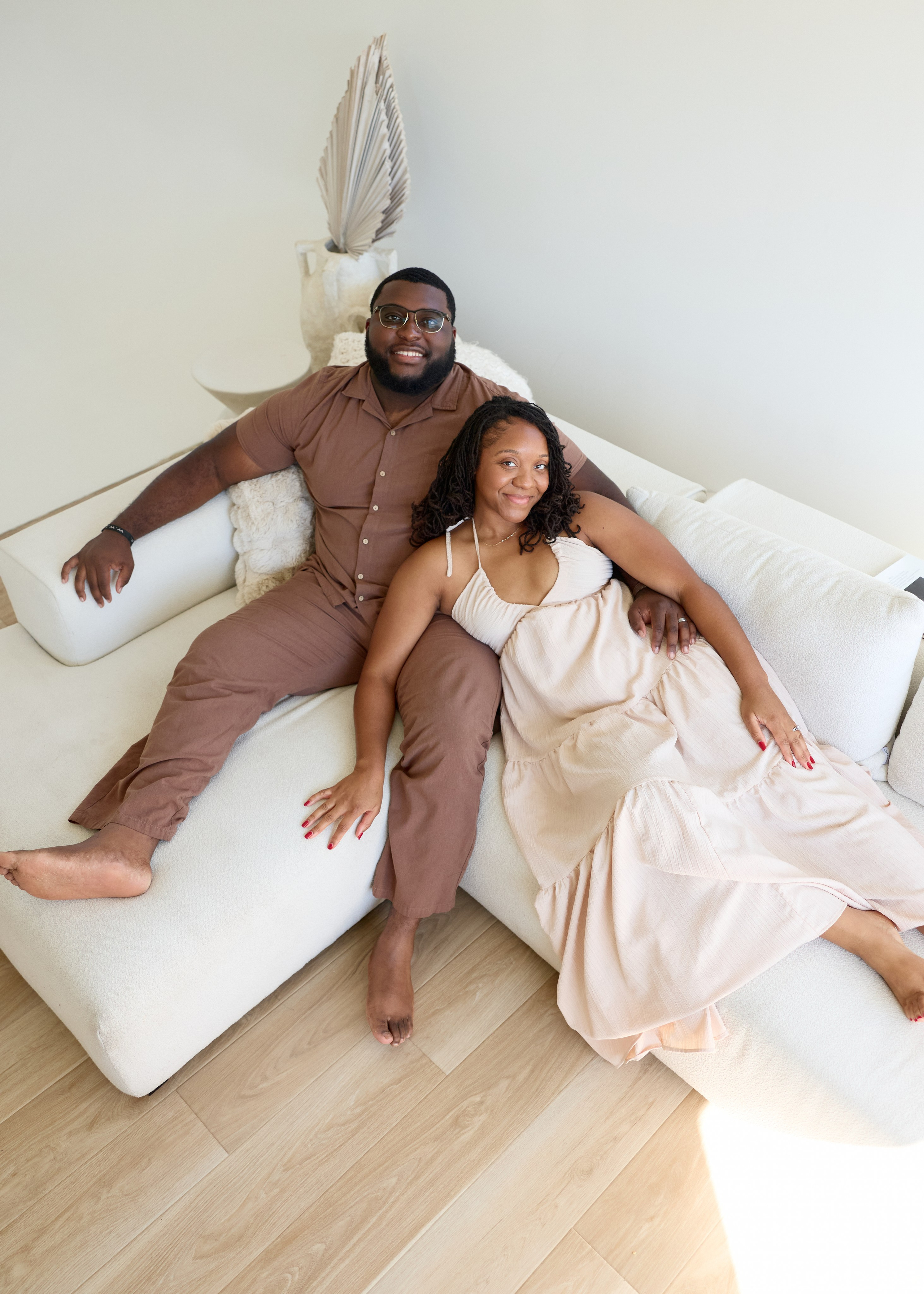 Relaxed lounge on a studio sofa during an engagement shoot in Columbus, Ohio