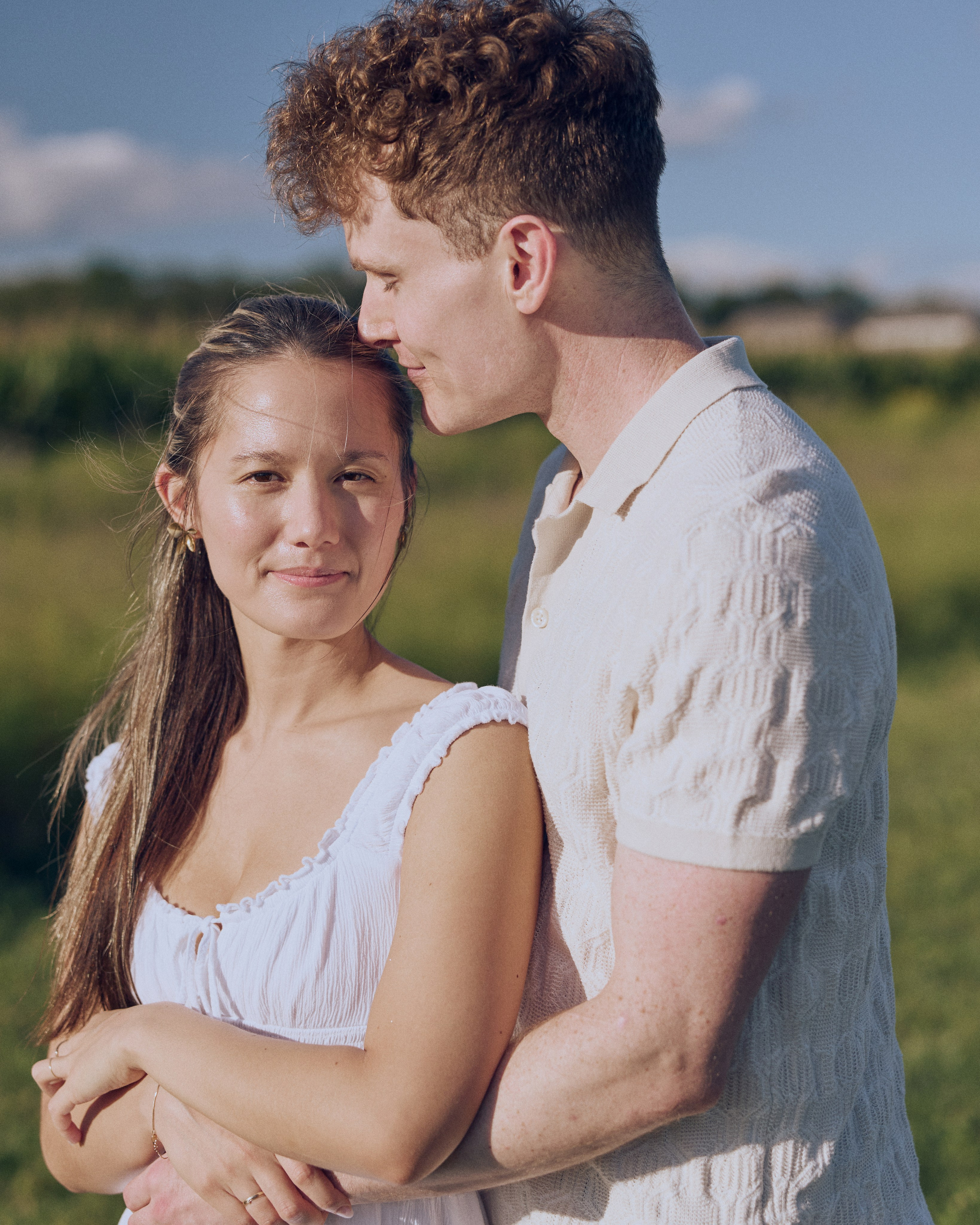 Engaged couple embracing at the edge of a cornfield near Columbus, Ohio