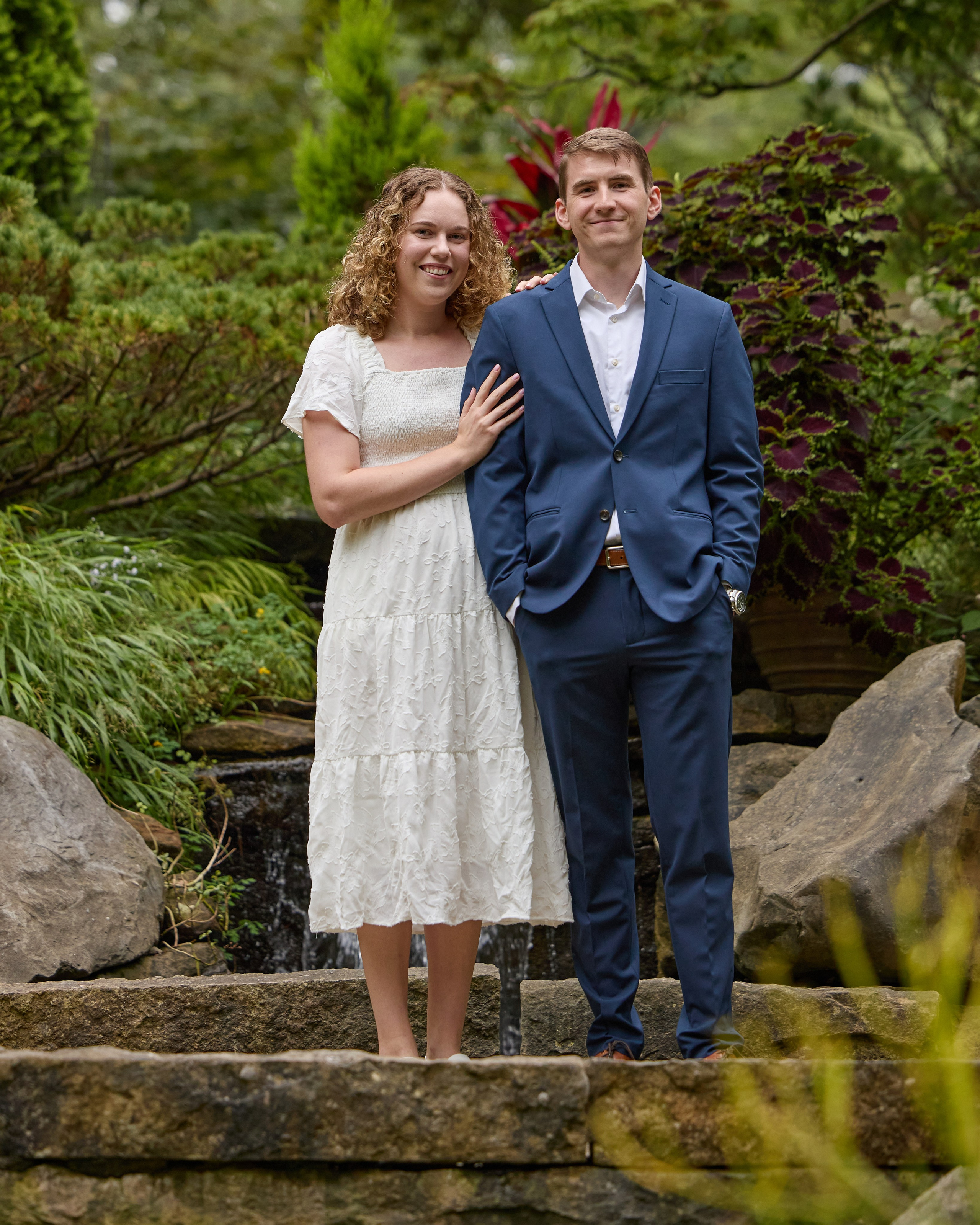 Engaged couple on stone steps in the gardens at Inniswood Metro Gardens, Ohio